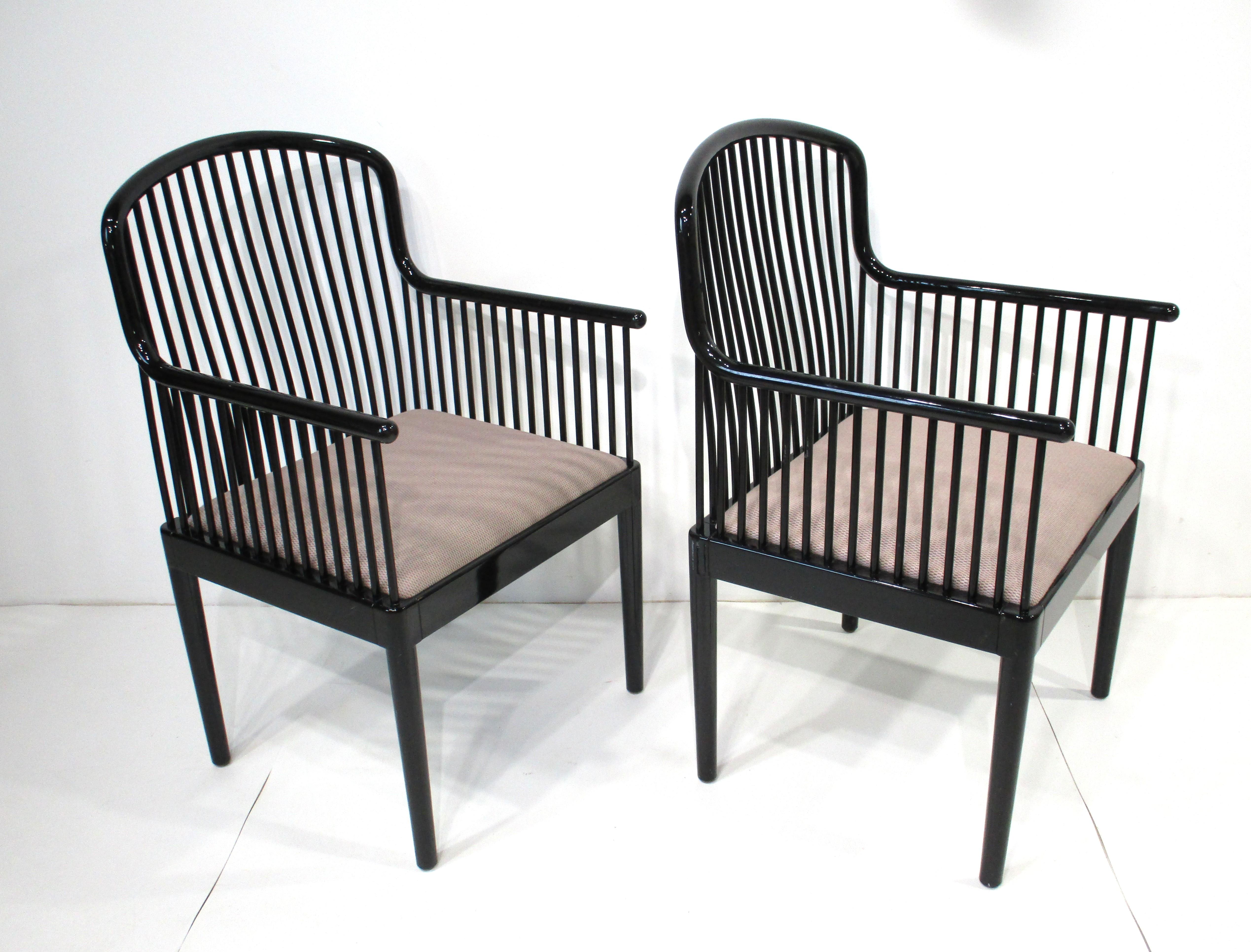 A pair of very well crafted, sophisticated and comfortable black lacquer wood framed armchairs with upholstered seat cushions. Manufactured for Stendig , the owners Charles and Eleanore were importers of the most avant-garde Italian designs to the