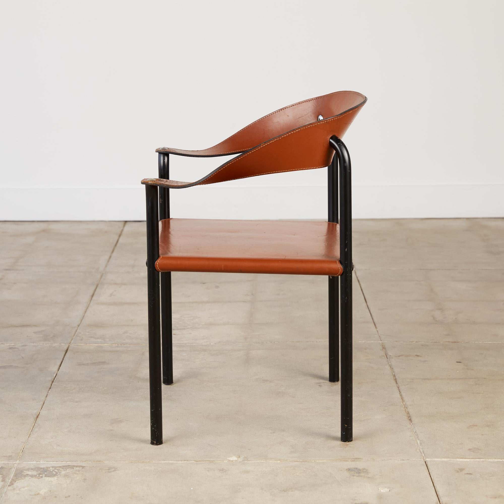 Armchair by Stendig, Finland, c.1950s. The chair features the original hand-stitched brown leather accented with metal hardware. The base is powder-coated in black and delicately carries a strap of leather that forms as the arms and backrest