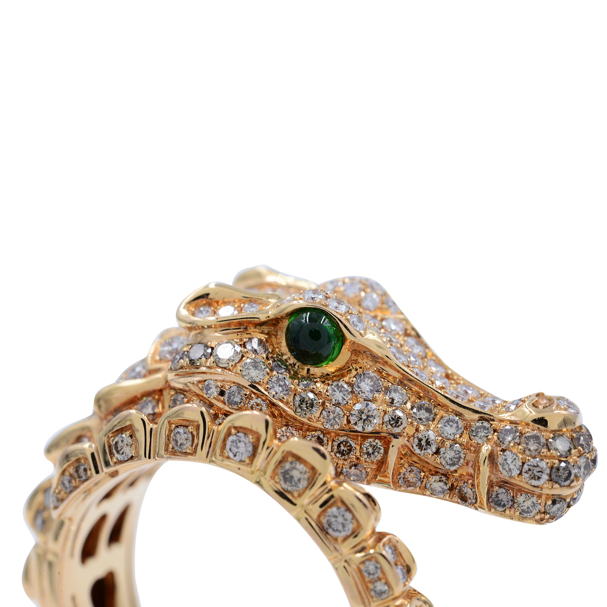 A spectacular fun and sexy gator ring featuring 1.00cts round brilliant cut diamonds. 
 
 The eyes of this fearsome creature are made of round cabochon emeralds. 
 
 This ring is a wrap around ring so can fit different finger sizes from 6.5 to size