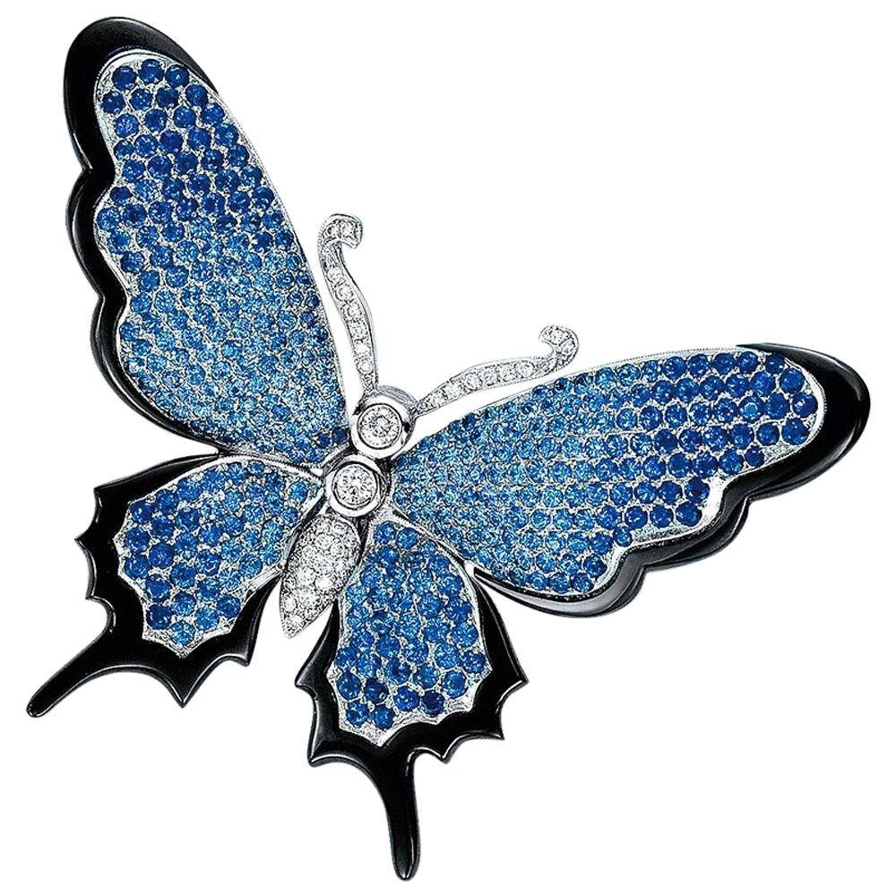 Stenzhorn Schmetterlingsbrosche aus 18 Karat Gold, blauem Saphir und Diamant mit schwarzem Onyx