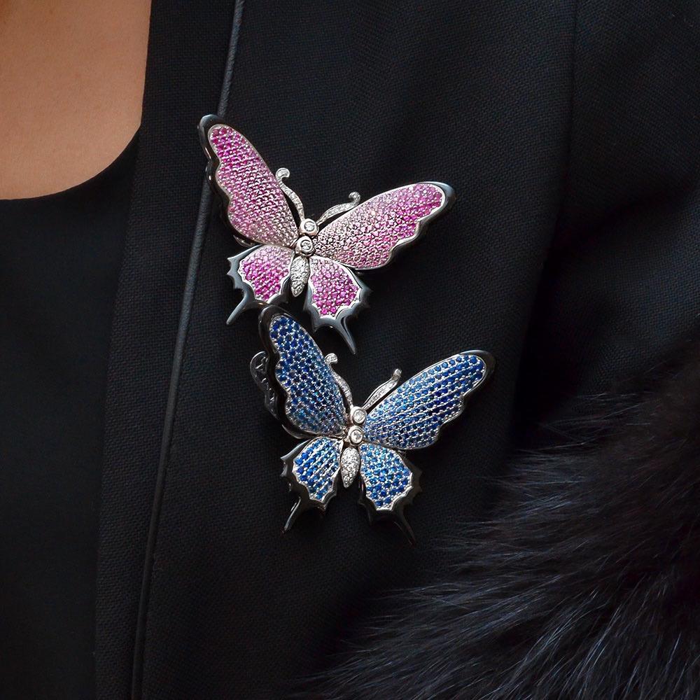 Butterfly wings in pink sapphire pavé graduating in color are edged with black onyx; set in 18-karat white gold. Moveable wings are spring-mounted to the diamond body so the wings can flutter.
The butterfly measures 2 5/8