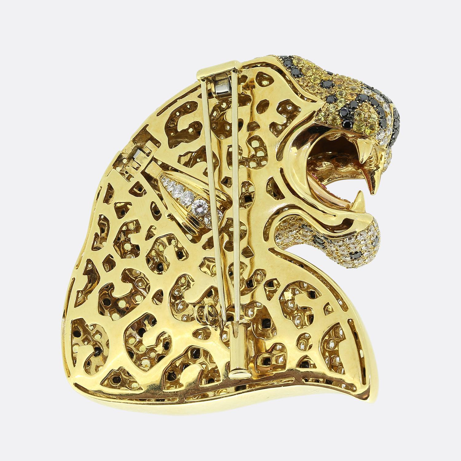 Here we have a captivating brooch come pendant masterfully designed in the form of a roaring panther. The piece is encrusted with a dazzling array of stones, featuring yellow sapphires as the primary stone, creating a vibrant and luxurious