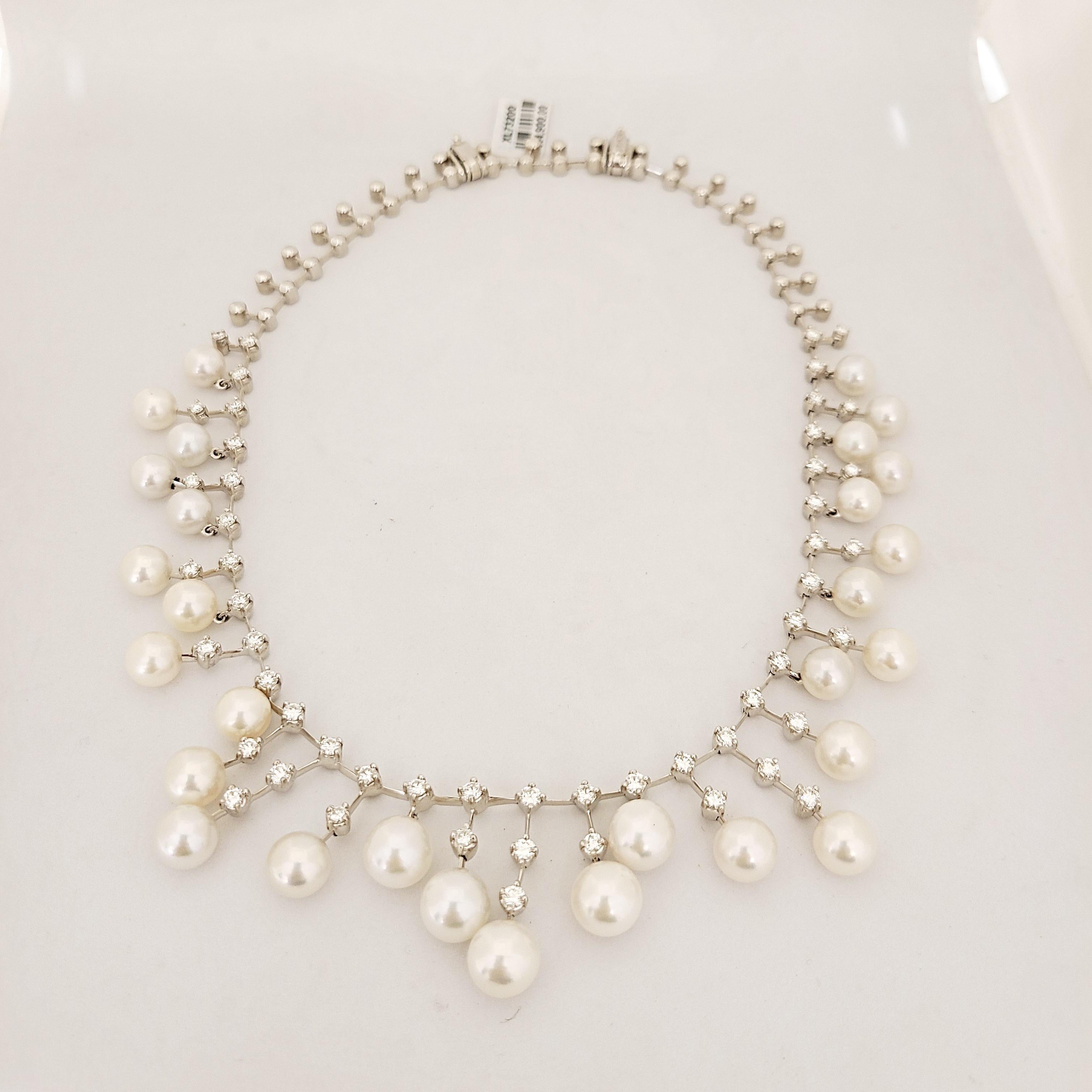 A beautifully designed showstopping 18 karat white gold necklace with floating diamonds and pearls. The necklace is set with 53 round brilliant diamond and 29 cultured pearls.  Designed with a removable section it can be worn at two different