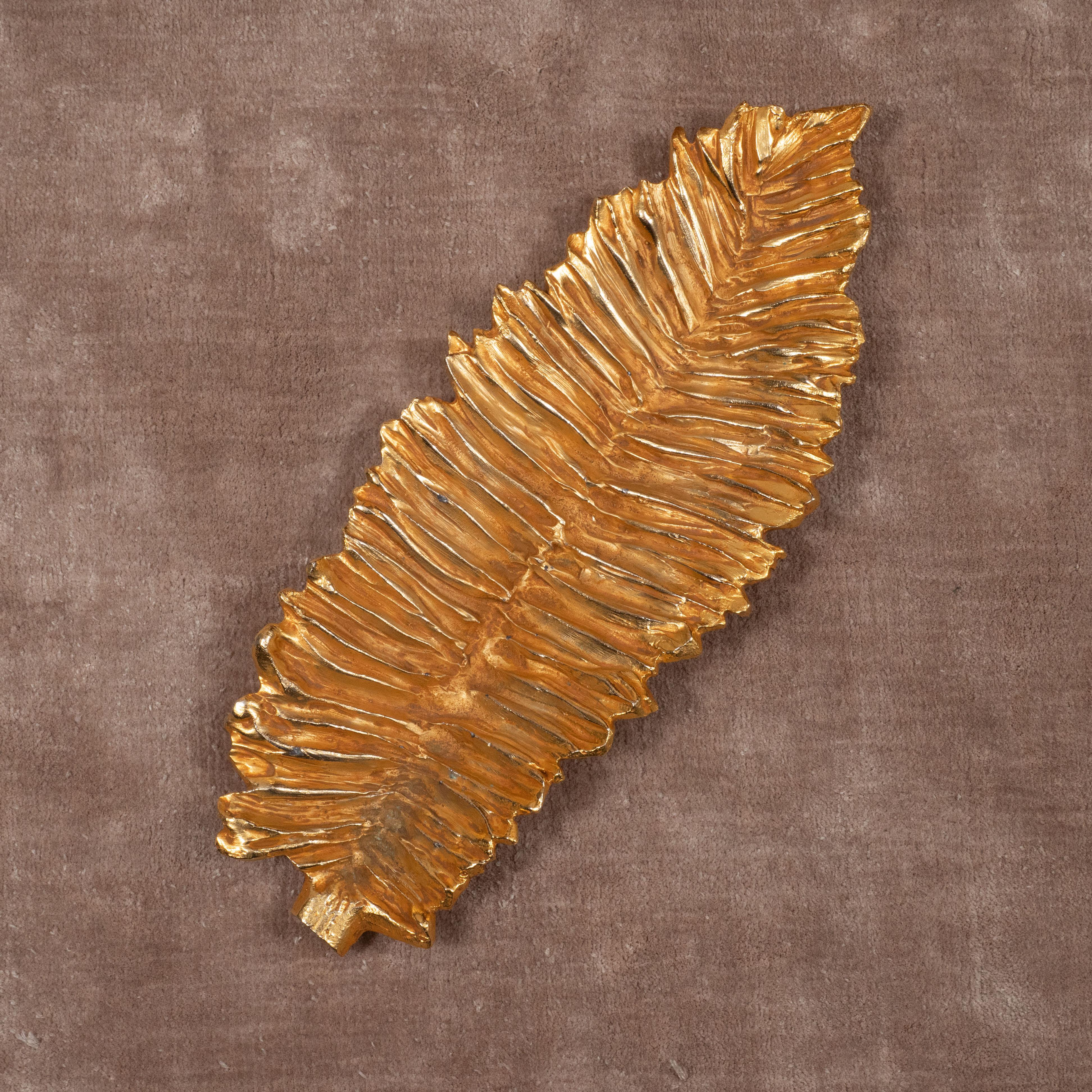 A dramatic, gilt metal decorative dish or low bowl by Stephane Galerneau in the shape of a long leaf. France, circa 1980.

Two available; priced individually. 

Measures 18