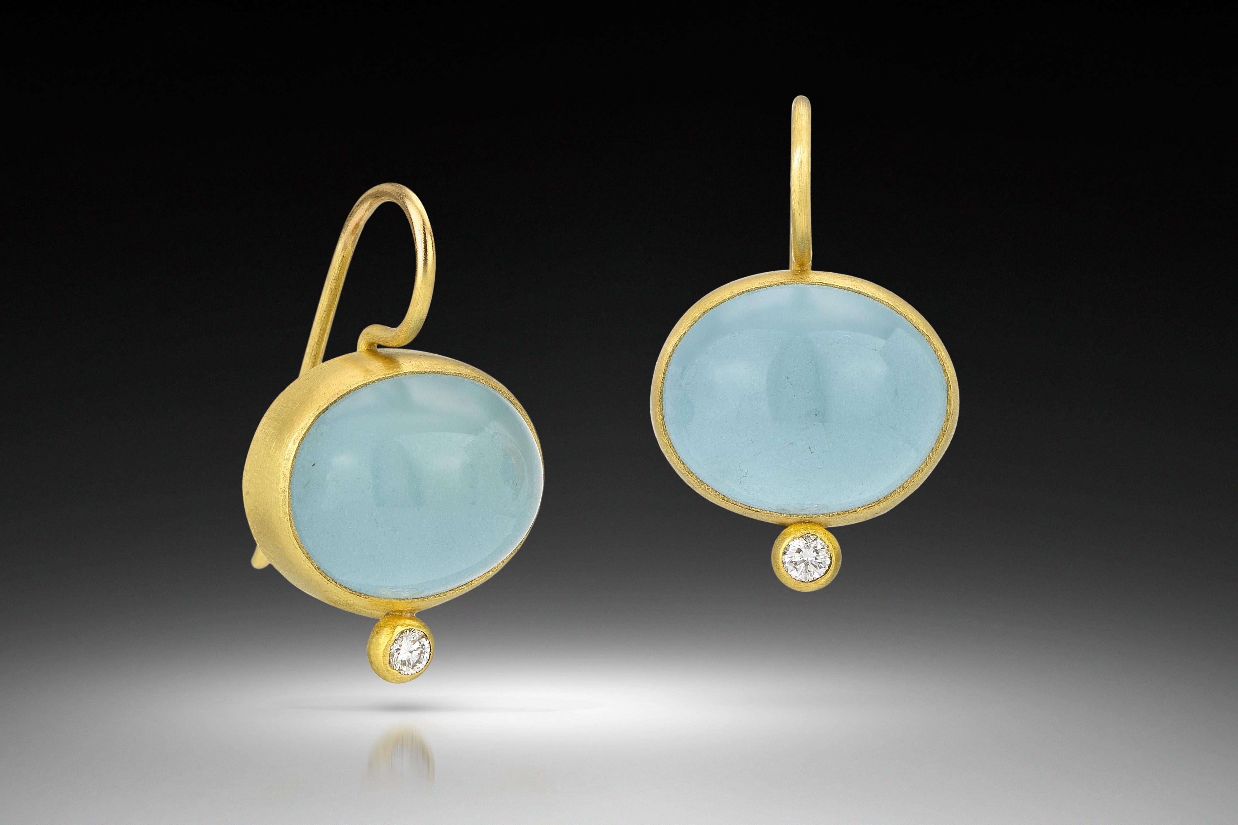 Stunning drop earring by Stephanie Albertson featuring 24.5 ct aquamarine oval cabochon, .10 ct diamond dot accents and French earwires. Designed to sit just below the earlobe, these earrings are perfect to wear every day or dress up for an evening
