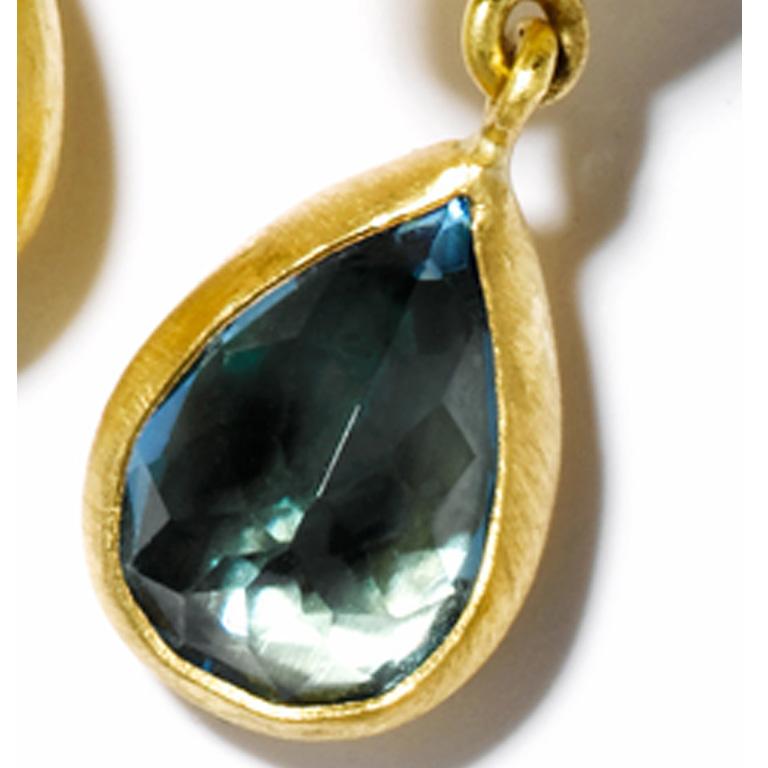 Hand crafted 22K gold & London blue topaz faceted, bezel-set double stone drop earrings by Stephanie Albertson. Each gemstone weighs 9.25 cts, and are custom cut in-house. Total carat weight per pair is approx 38 cts.  Earrings feature a cushion cut