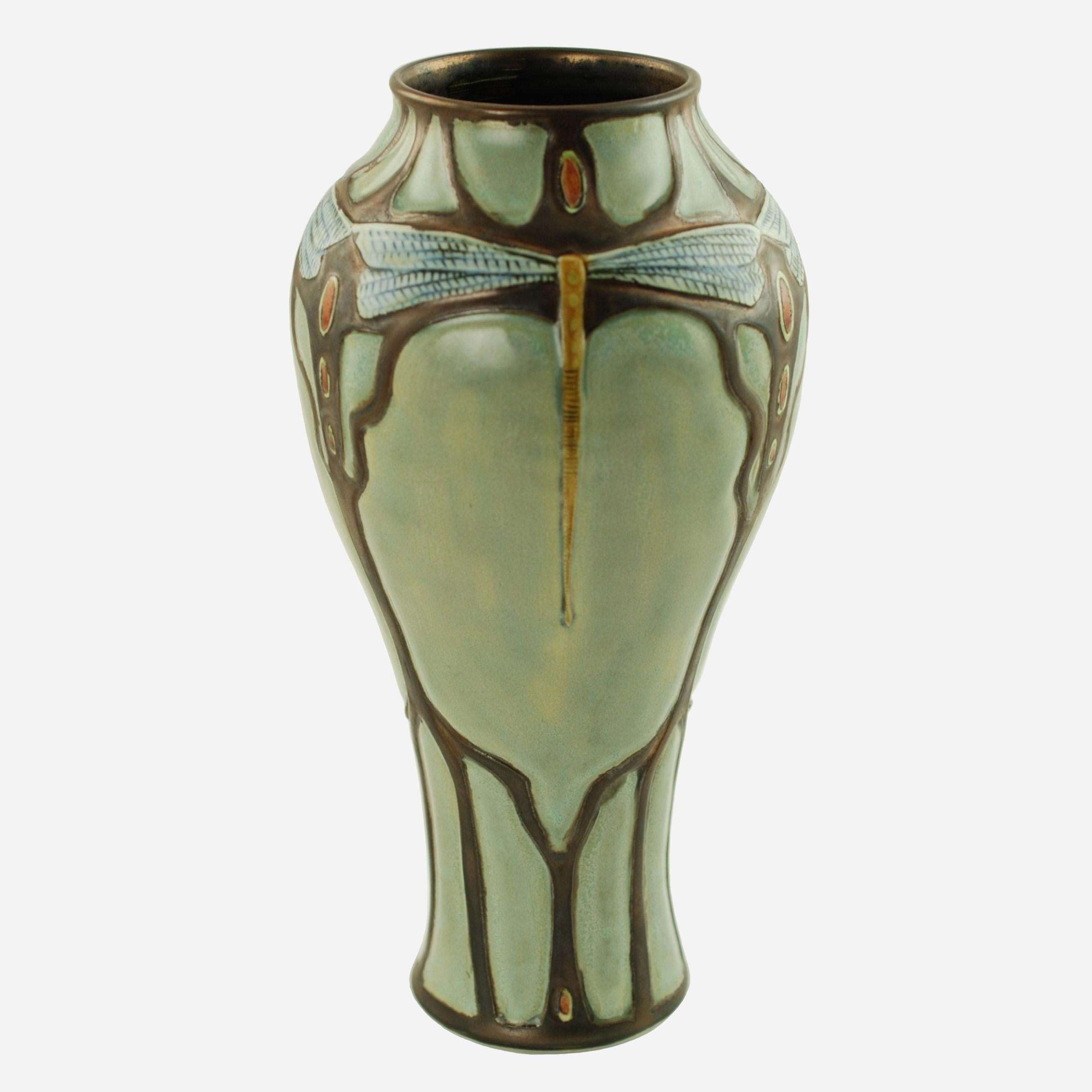 This lovely Art Nouveau-style vase was made by New Hampshire-based artisan Stephanie Young of Calmwater Designs.  The hand-thrown porcelain vase has a classic baluster form with hand-carved decoration and features three large dragonflies with long