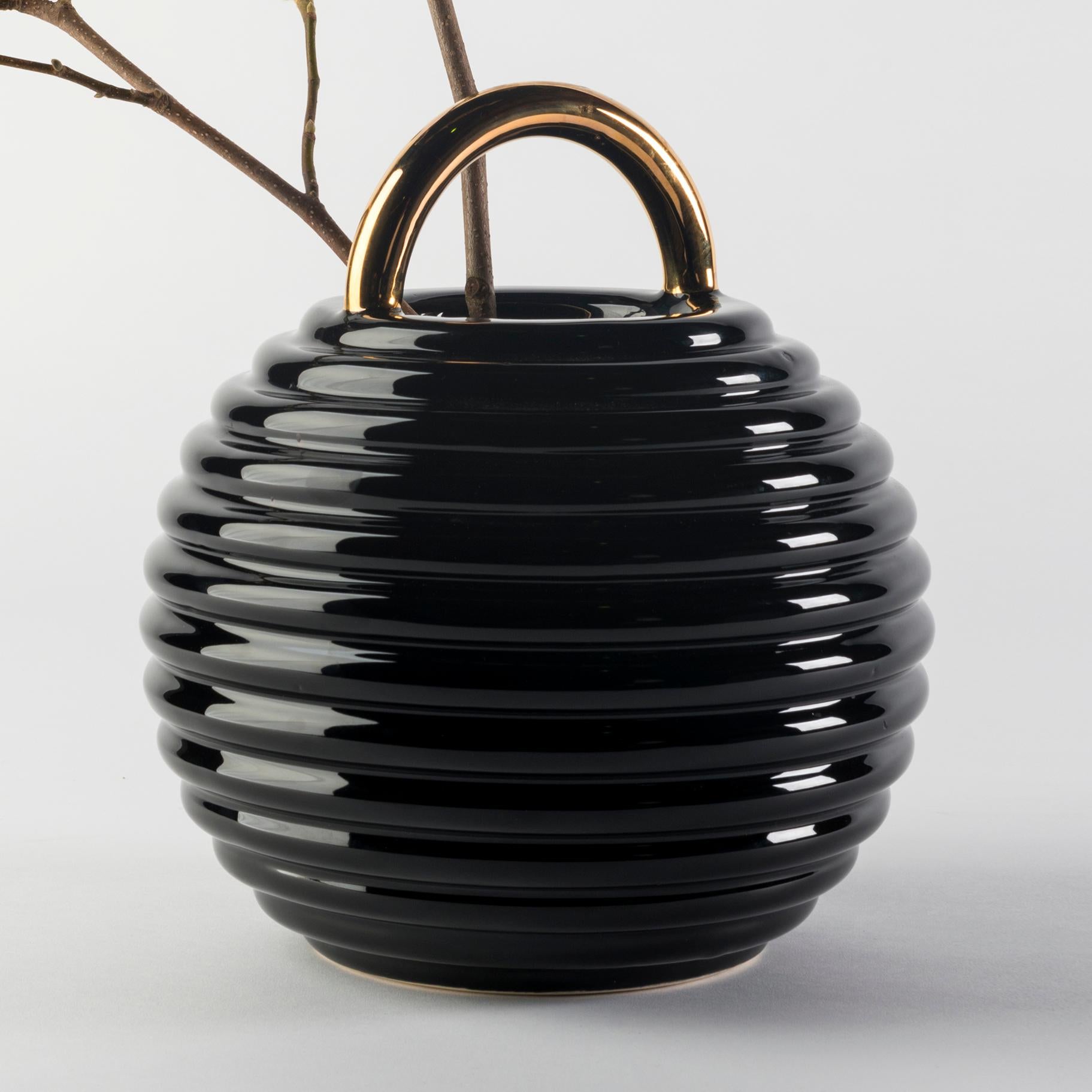 Ceramic vase designed by Stephen Burks 

Black enamelled ceramic vase with hand painted decorations in gold, platinum and copper.

The Grasso vases come in different finishes. The basic versions are either all in white or black with the handle