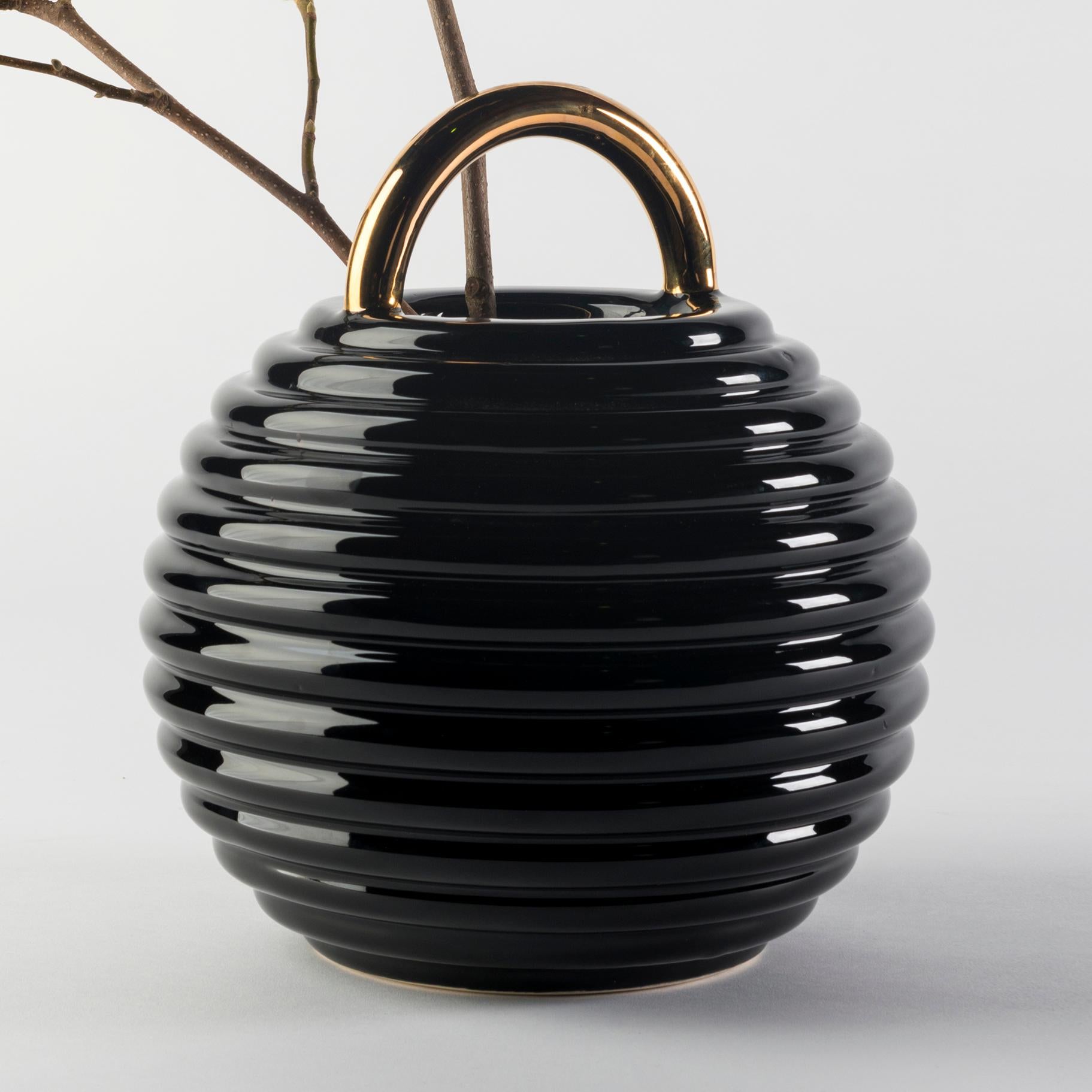 Ceramic vase designed by Stephen Burks 

Black enameled ceramic vase with hand painted decorations in gold, platinum and copper.

The Grasso vases come in different finishes. The basic versions are either all in white or black with the handle