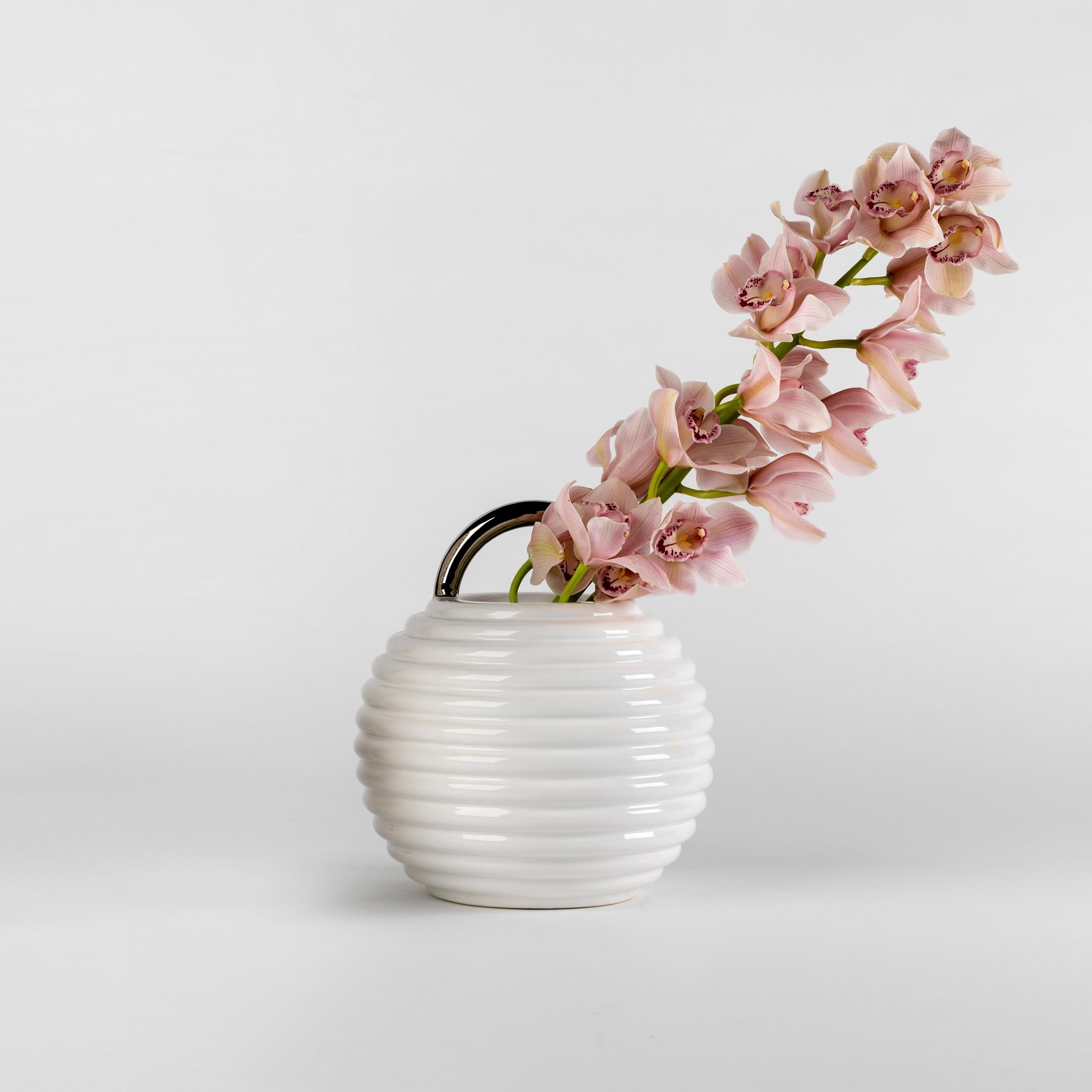White enamelled ceramic vases with hand-painted decorations in gold.

Single: Ø27 x H.30 cm 

The Grasso vases come in different finishes. The basic versions are either all in white or black with the handle painted in gold. There are also hand