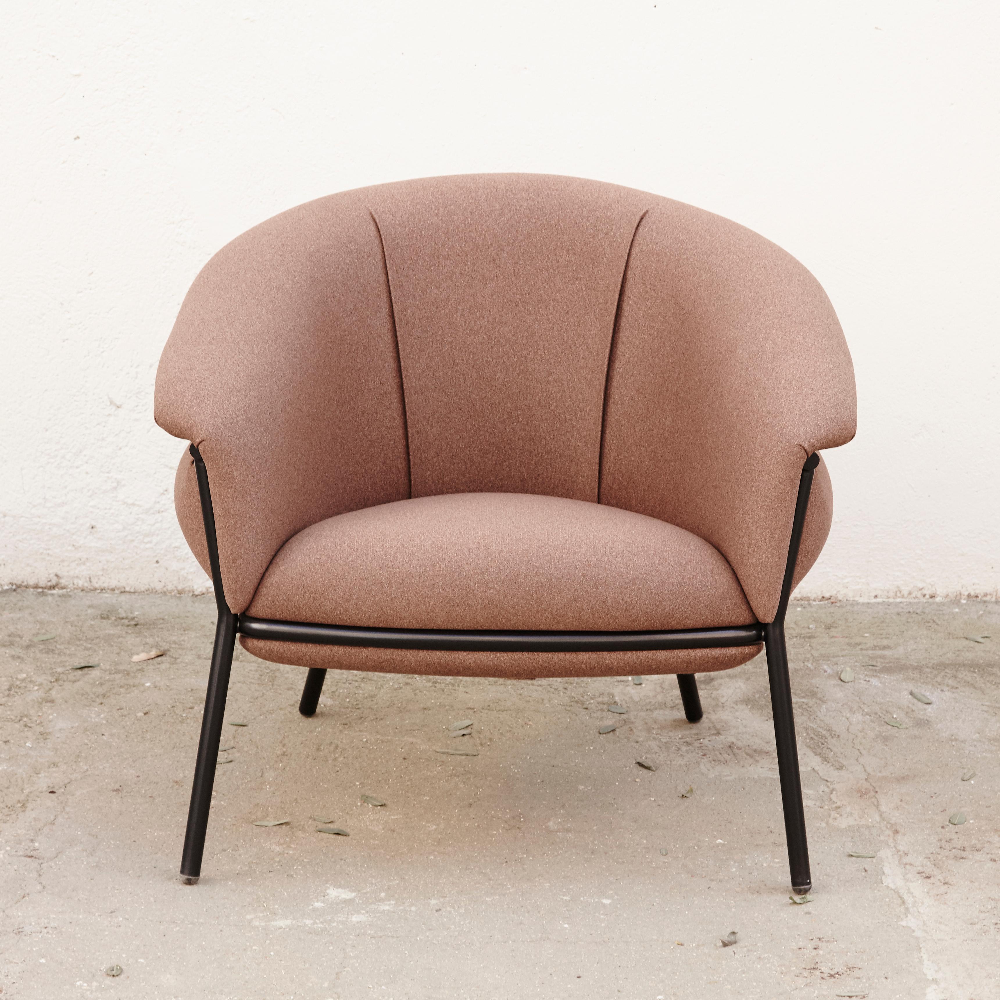 Armchair designed by Stephen Bruks manufactured by BD Barcelona.

An iron tubular (25mm) structured armchair. Seat and backrest upholstered in fabric.

The fabric upholstery oozes over the bare iron structure to contrast with the most luxurious