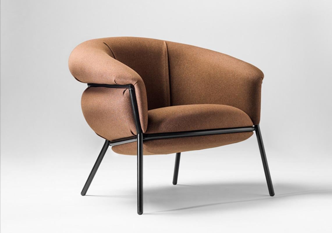 Armchair designed by Stephen Bruks manufactured by BD Barcelona.

An iron tubular (25mm) structured armchair. Seat and backrest upholstered in fabric.

The fabric upholstery oozes over the bare iron structure to contrast with the most luxurious