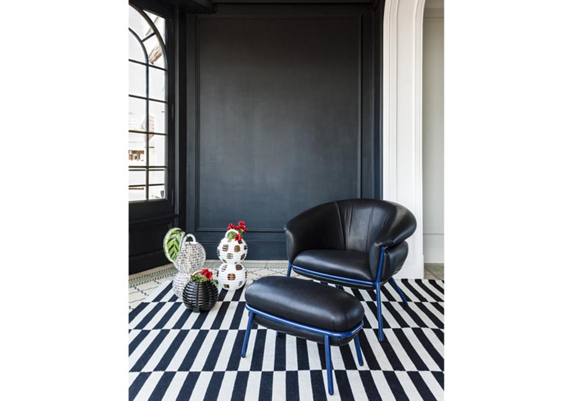 Armchair and foot stool designed by Stephen Bruks manufactured by BD Barcelona.

An iron tubular (25mm) structured armchair. Seat and backrest upholstered in leather.

The leather upholstery oozes over the bare iron structure to contrast with