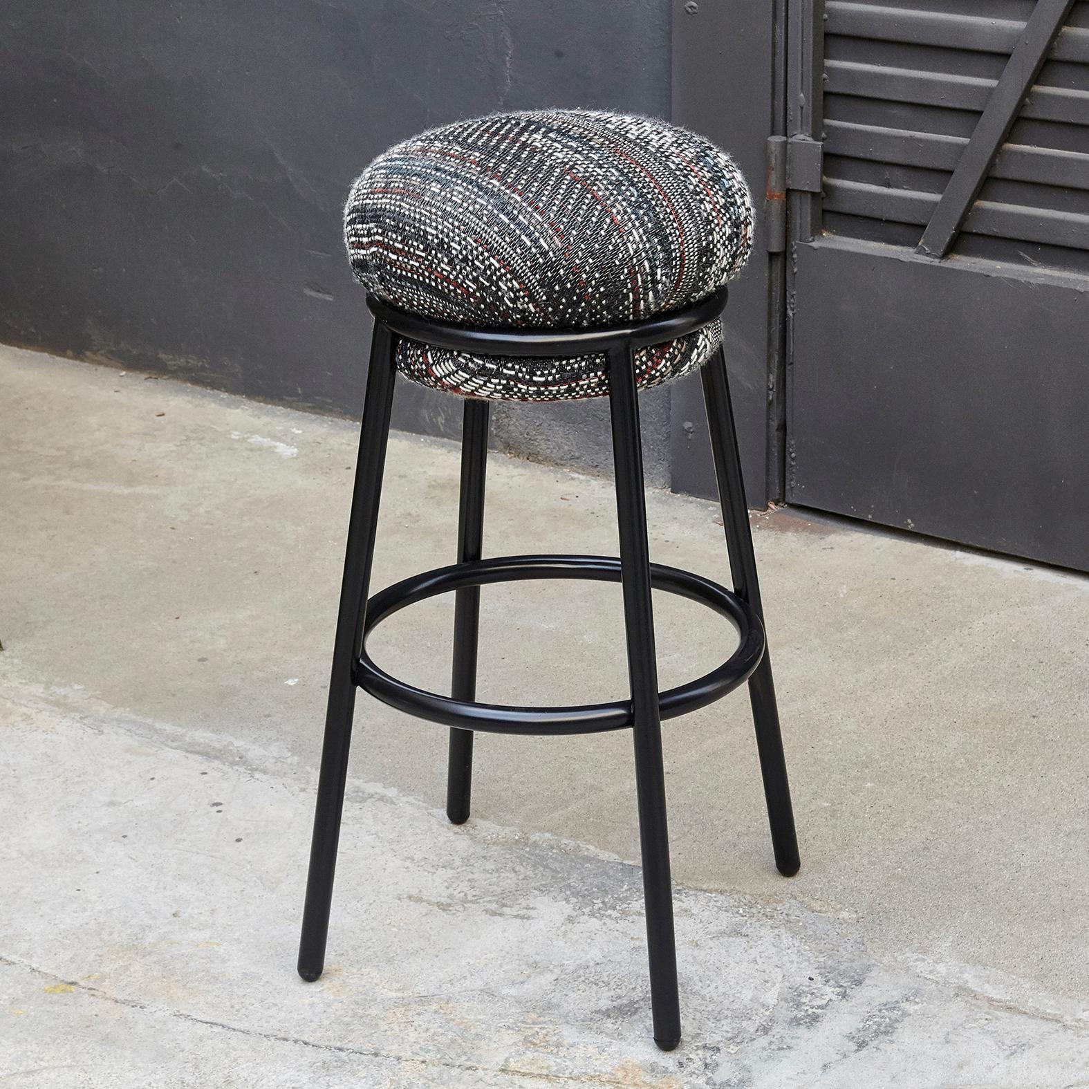 Bar stool designed by Stephen Burks manufactured by BD Design Barcelona
An iron tubular (25mm) structured armchair. Seat and backrest upholstered in fabric.

The fabric upholstery oozes over the bare iron structure. 

Measure: Ø36 x H 80