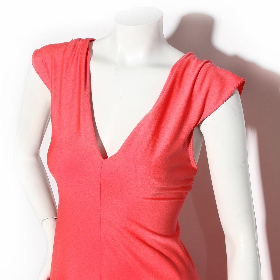 Stephen Burrows Dress
Vintage 
Circa 1970's 
Made in the United States 
Coral color 
Knit jersey fabric
V-neckline 
Knotted and drape detail on back on dress
Cut-Out detail in back 
Vent in back of dress
Floor length 
Stitch detailing at hems