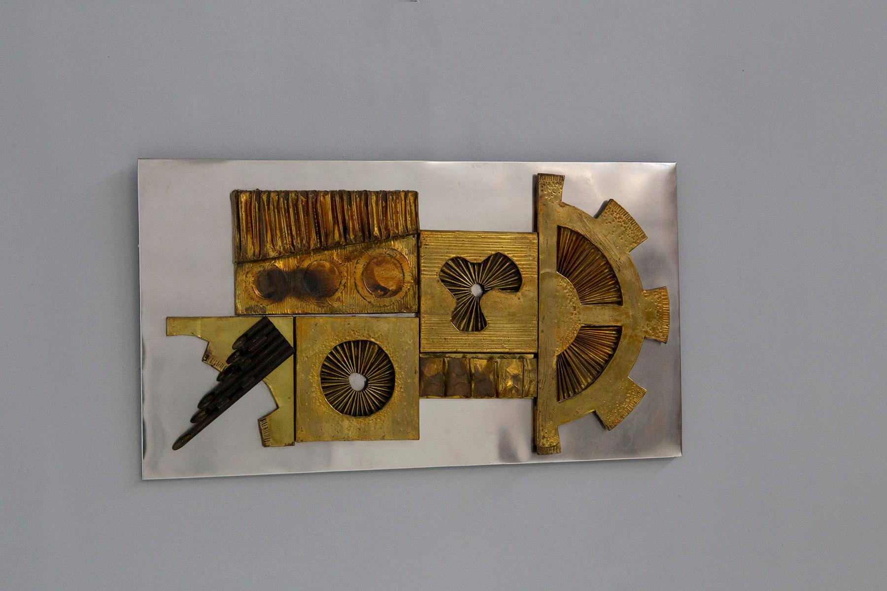 Decorative wall sculpture from the 1970s. The 'work is by artist and creator Stephen Chun. The work is mounted from a metal panel where his artwork is later applied. The sculpture is made of different metals, such as bronze, brass, and copper, which