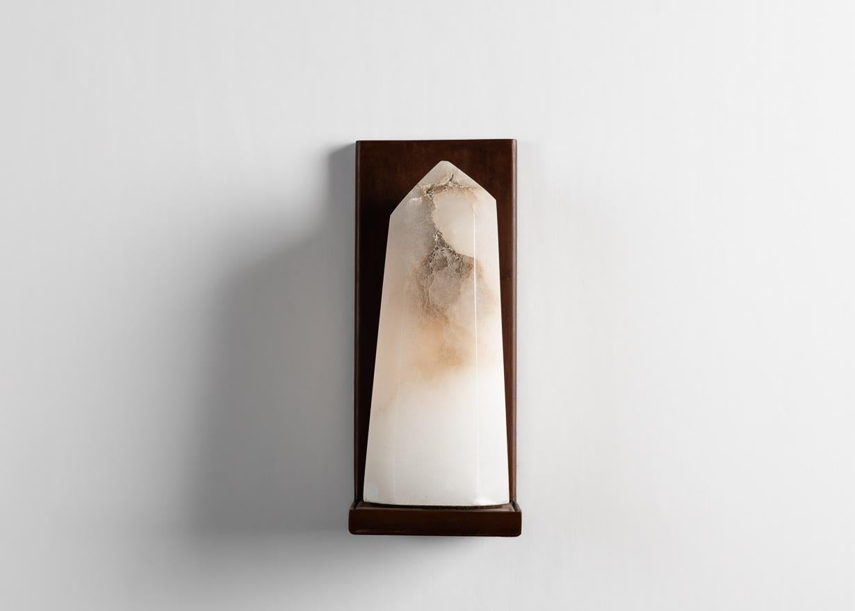 This elegant sconce by Stephen Downes, alabaster expert and student of Master Stone Carver René Lavaggi, is made of polished alabaster and patinated steel, and emits a soft light through its thick alabaster shade.