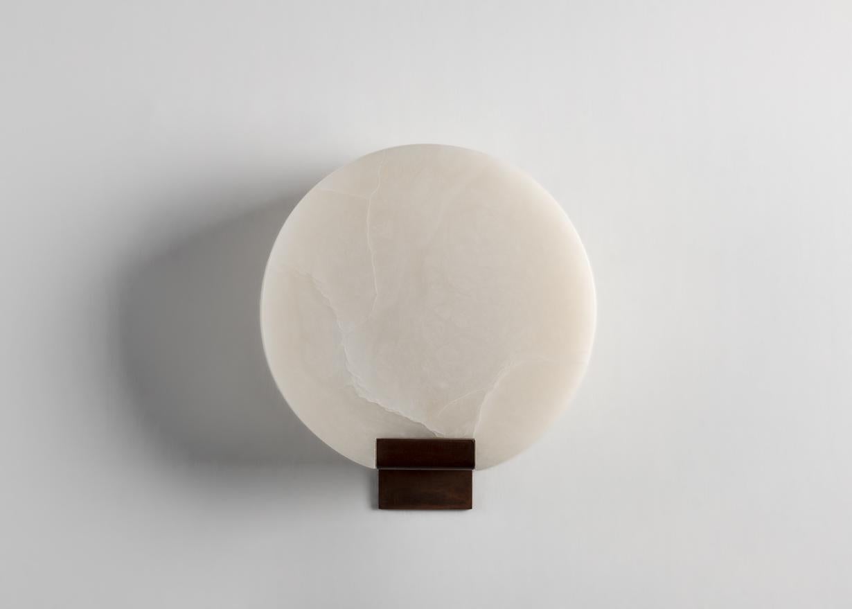 This elegant sconce by Stephen Downes, alabaster expert and student of Master Stone Carver René Lavaggi, mimics the moon in its shape, color, and with the soft light emitted through its thick alabaster shade. This listing is a set of