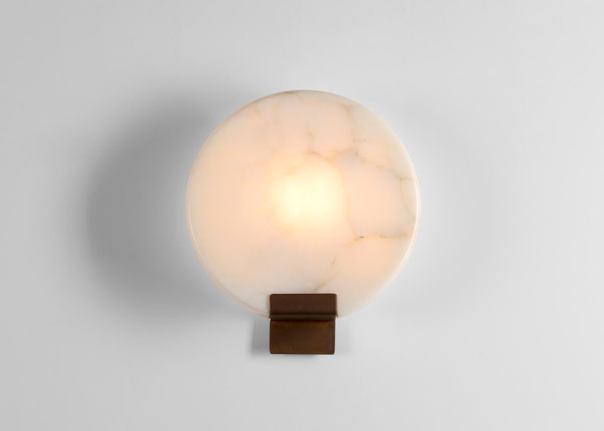 This elegant sconce by Stephen Downes, alabaster expert and student of Master Stone Carver René Lavaggi, mimics the moon in its shape, color, and with the soft light emitted through its thick alabaster shade.

Designed for one 60 watt bulb with a