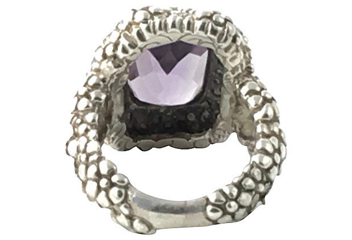 Stephen Dweck sterling silver textured beaded flowers ring with bezel set faceted rectangular purple amethyst center stone. 

US size 5.75. It can be sized. Marked Sterling & Dweck