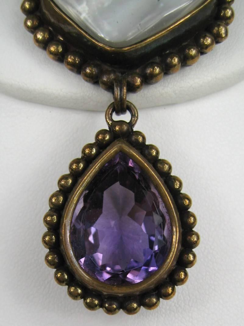 Stephen Dweck Bronze Brooch with a bezel set Amethyst and Mother of pearl measuring 2.35 top to bottom x 1.35. Circa 1980s Early Stephen Dweck. We have many more pieces of Dweck listed on our storefront. This collection consists of items purchased