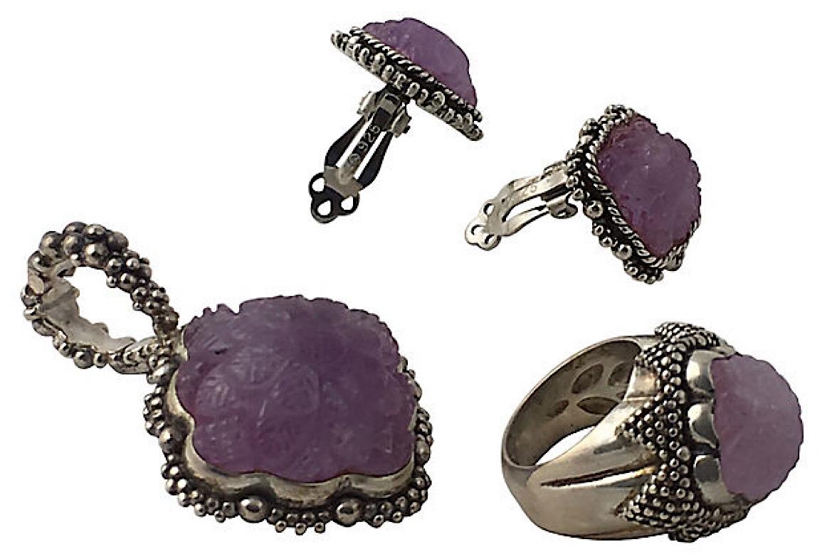 Sterling silver and amethyst Stephen Dweck earrings, ring, and pendant set. Clip-back earrings feature sculpted beads and a carved amethyst with floral motif. Pendant features a carved amethyst with floral motif and beaded frame with beaded accents