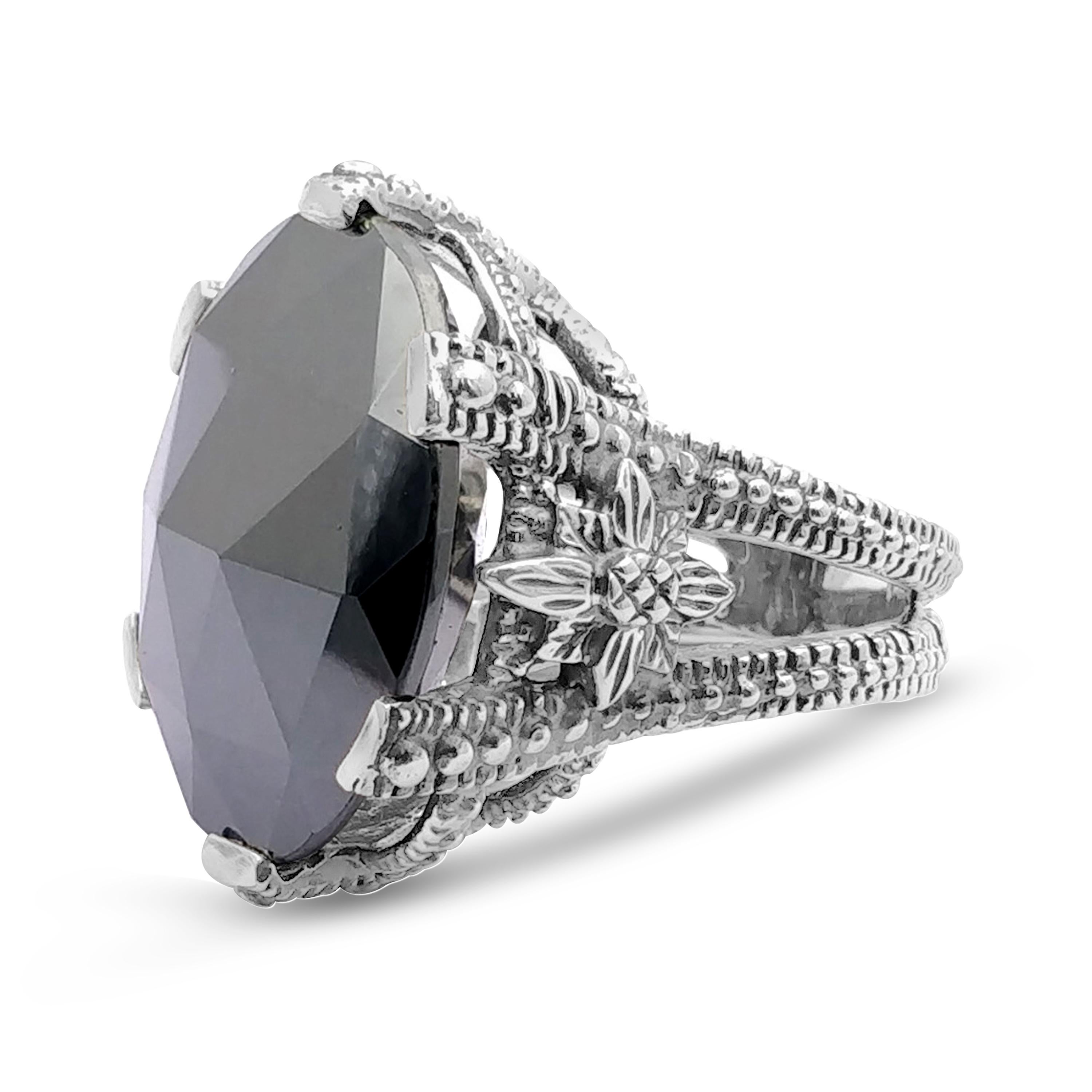 This adventurous Stephen Dweck Sterling Silver Statement Ring features a faceted Hematite (28mm) held by a floral carved basket of sterling silver. Drawing inspiration from a love of nature and passion for art, each Stephen Dweck creation is a