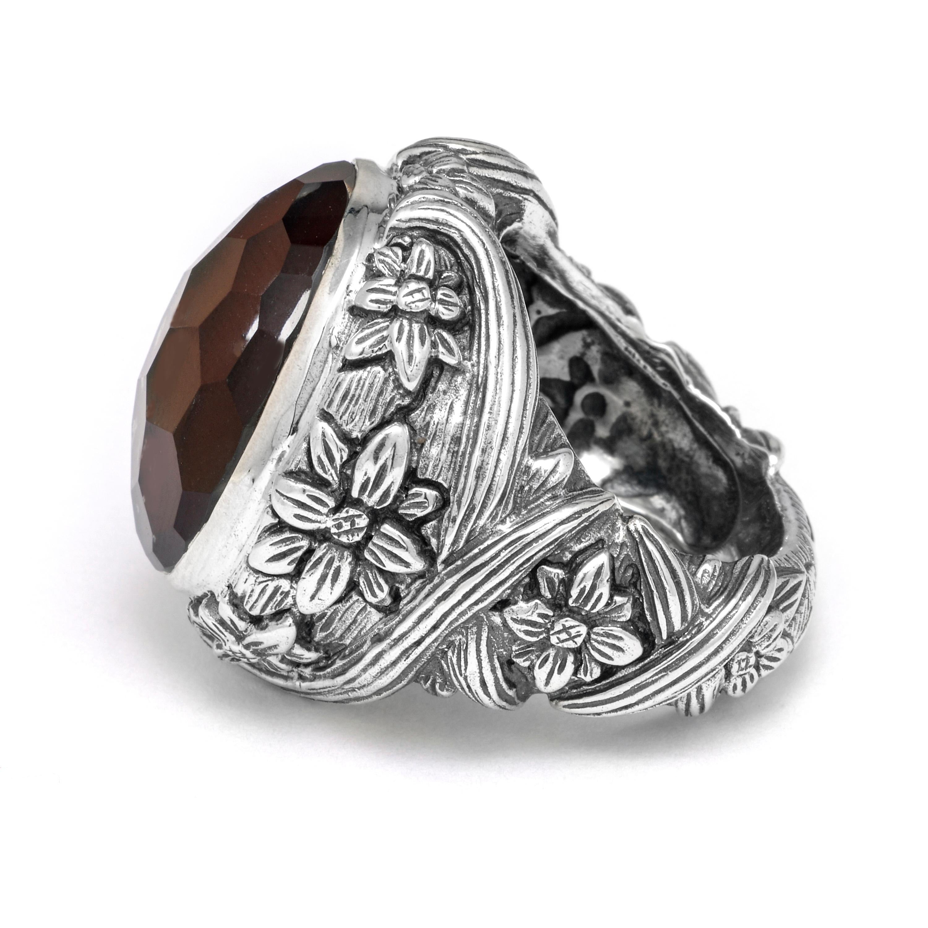 This dramatic Stephen Dweck Sterling Silver Dome Ring features a faceted Smoky Quartz and Mother of Pearl doublet (18mm x 21mm) enhanced with wrapping vines and floral details of sterling silver. Drawing inspiration from a love of nature and passion