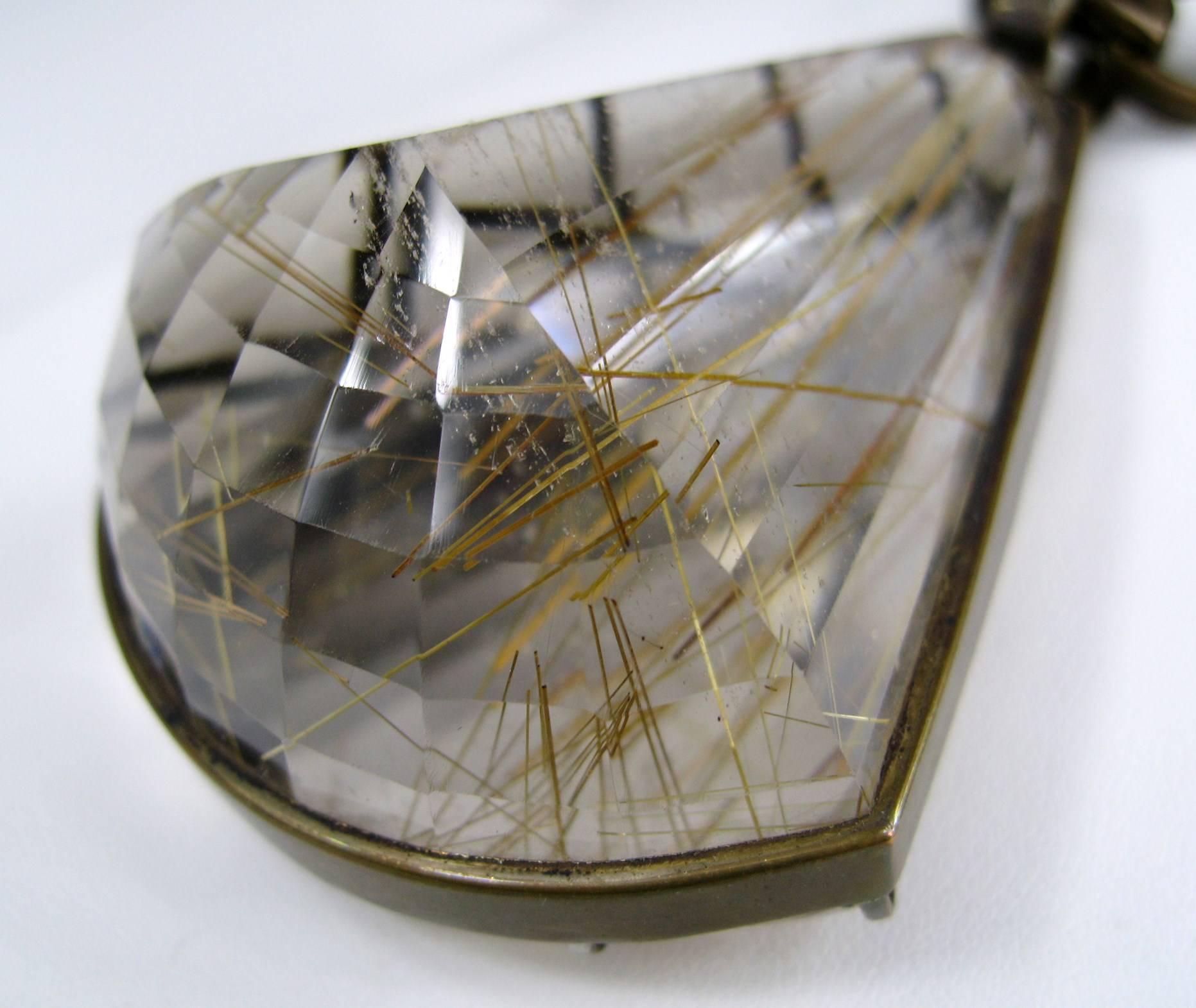 Stunning 1990s Stephen Dweck Bronze Rutilated quartz. The necklace measures approximately 32 inches long and drop down to about 39 inches, no clasp. The caged quartz measures 2.12 inches at the widest x 3.00 inches top to bottom. This is out of a