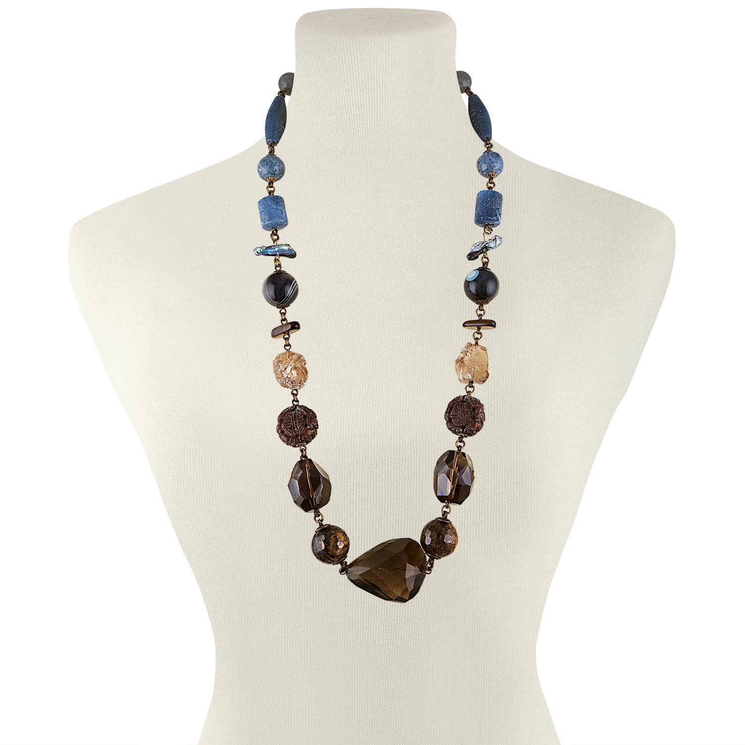 Stephen Dweck Long Necklace
The necklace is brass 
There is Blue Coral, Topaz, Cultured Pearl, Agate, Crystal, Tiger Eye, etc.
The necklace is 30