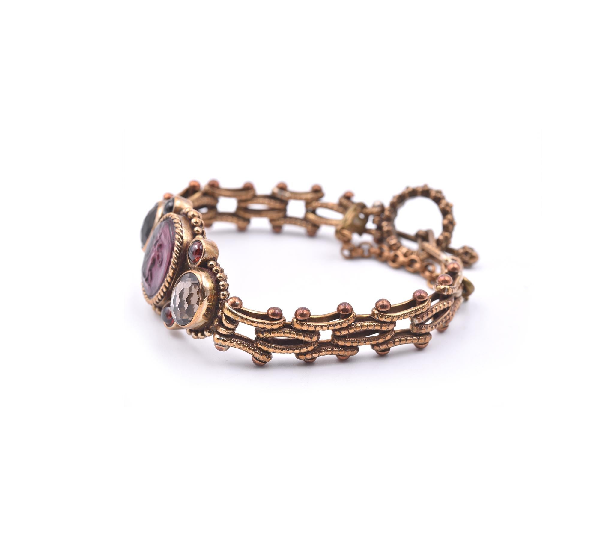 Designer: Stephen Dweck
Material: sterling silver
Gemstones: 4 cabochon garnets, 2 oval faceted smoky quartz
Dimensions: bracelet will fit up to a 7.5-inch wrist
Weight: 35.26 grams	
