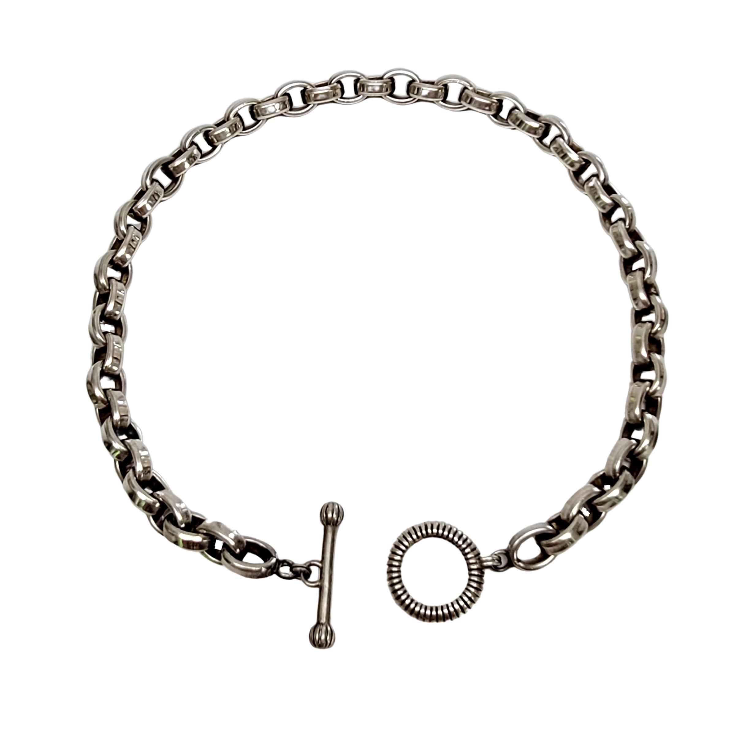 Sterling silver rolo link necklace with toggle closure by Stephen Dweck.

Designed by Stephen Dweck, this heavy and substantial smooth oval shaped rolo link necklace with textured toggle closure.

Measures approx 17