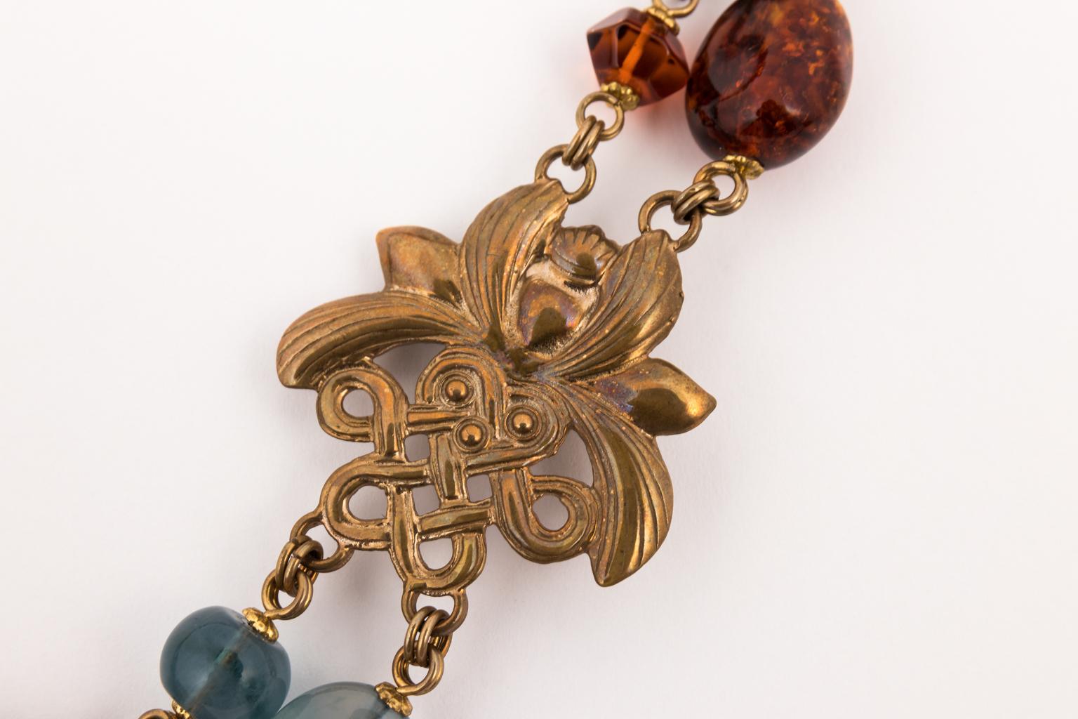 1990s Stephen Dweck sterling and stone necklace in a Chinese style with lotus flower and endless knot motifs. There are two large amber cabochons and each is 1 1/8 X 7/8 inches with the mounting. The center piece is one large landscape agate stone