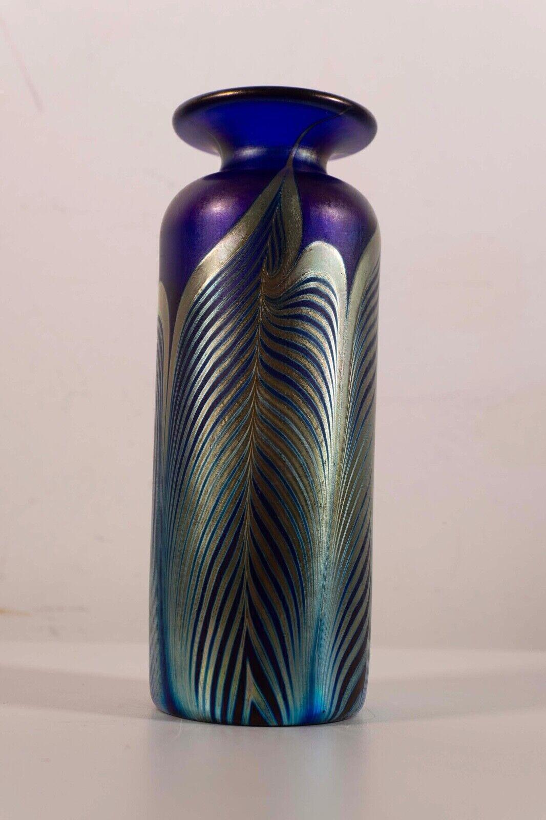 This Stephen Fellerman signed small glass vase beautifully channels the Art Nouveau style with its exquisite blend of blue and green hues. The sinuous lines and delicate patterns evoke the timeless elegance of the Art Nouveau era, while the artist's