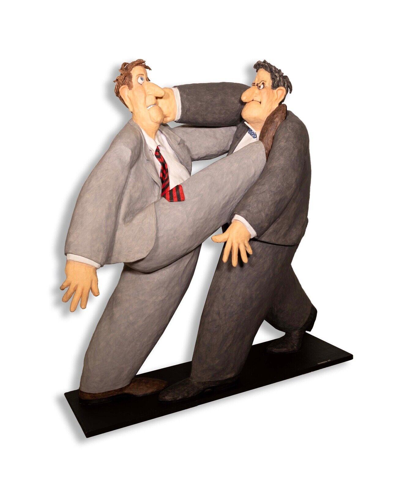 An amusing and humorous papier mache sculpture depicting two business men expressively fighting titled 