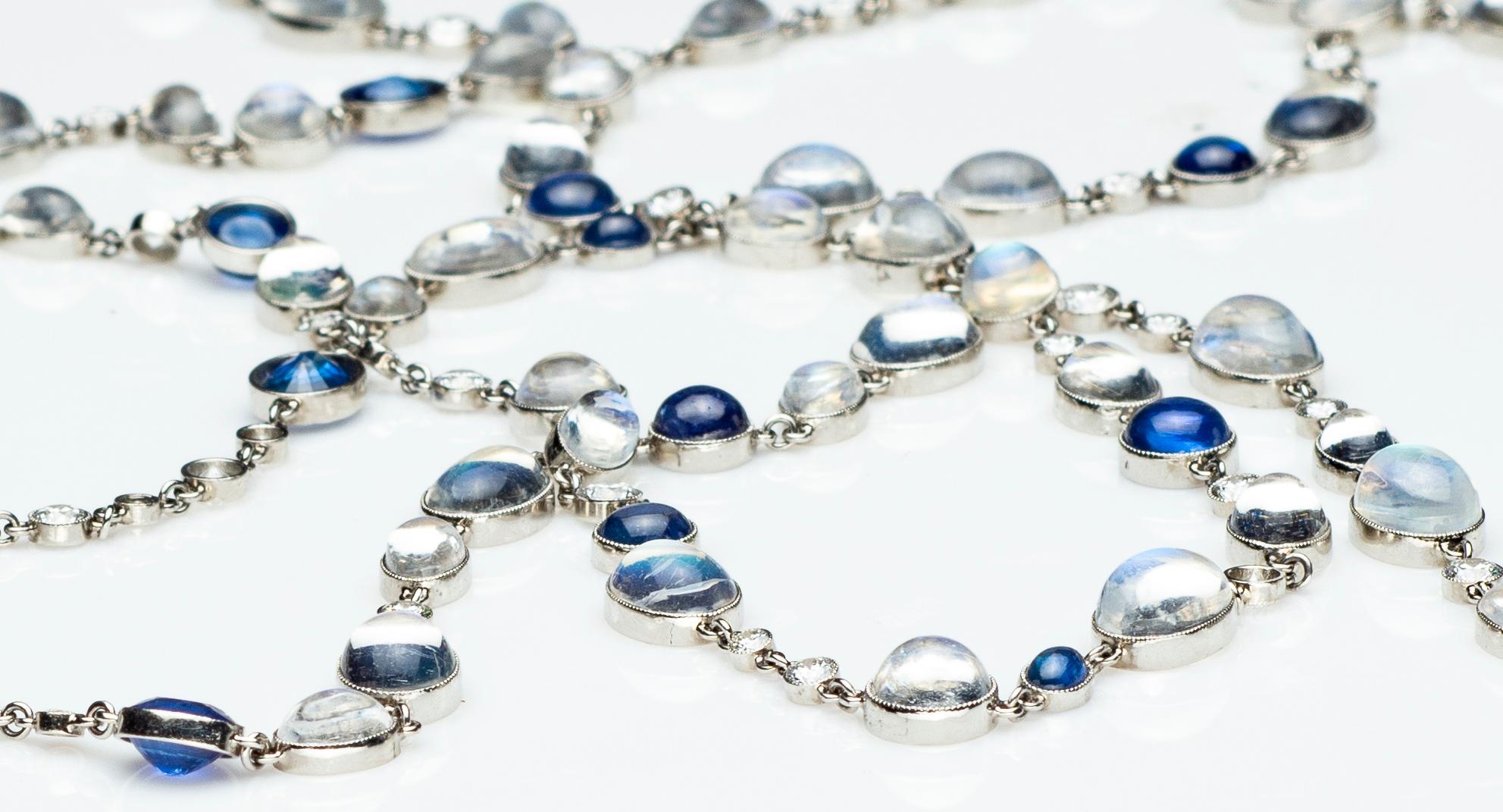 Stephen Russell Moonstone Diamond and Sapphire Chain Set in Platinum; 93 Diamonds 6.53ct; 100 Moonstones 87.92ct;  32 Sapphires 26.92ct; Length 72” 

Cabochon moonstones of exceptional adularescence are the focal point of this beautiful chain. The
