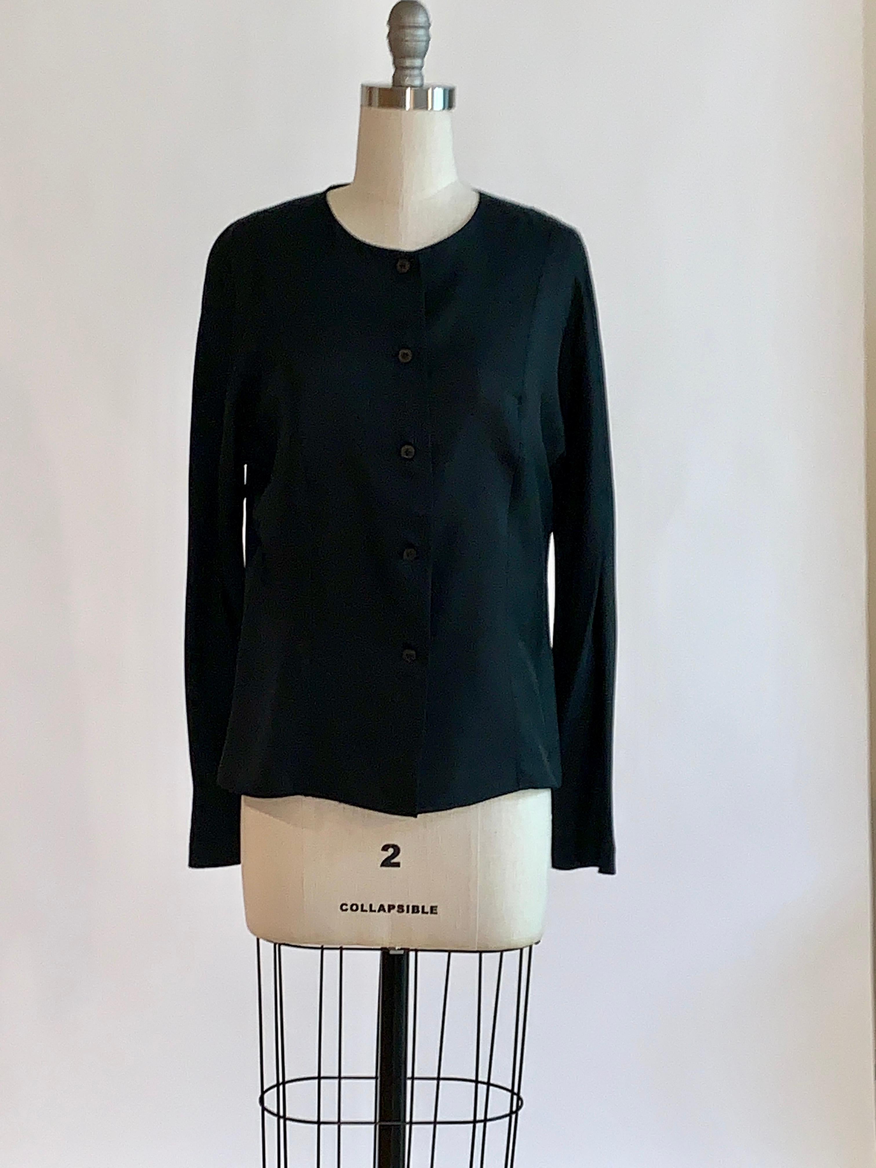 Sprouse by Stephen Sprouse black silk long sleeve blouse with round neck, button front, and long sleeves. Princess seam detail at front and back creates a tailored shape. 

100% silk. 

Made in Korea.

Labelled size 6, best fits S/M. See