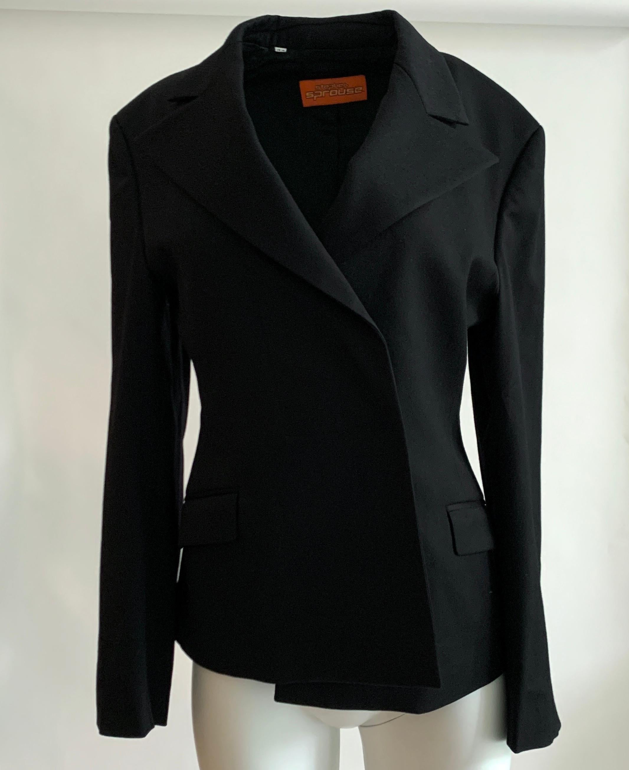 Vintage Stephen Sprouse black blazer in a classic cut with  velcro closure at front. Circa 1990s. Flap pockets at front and a flap detail at cuffs that also fasten with velcro. The buttonless front gives a super clean and modern look to a tried and