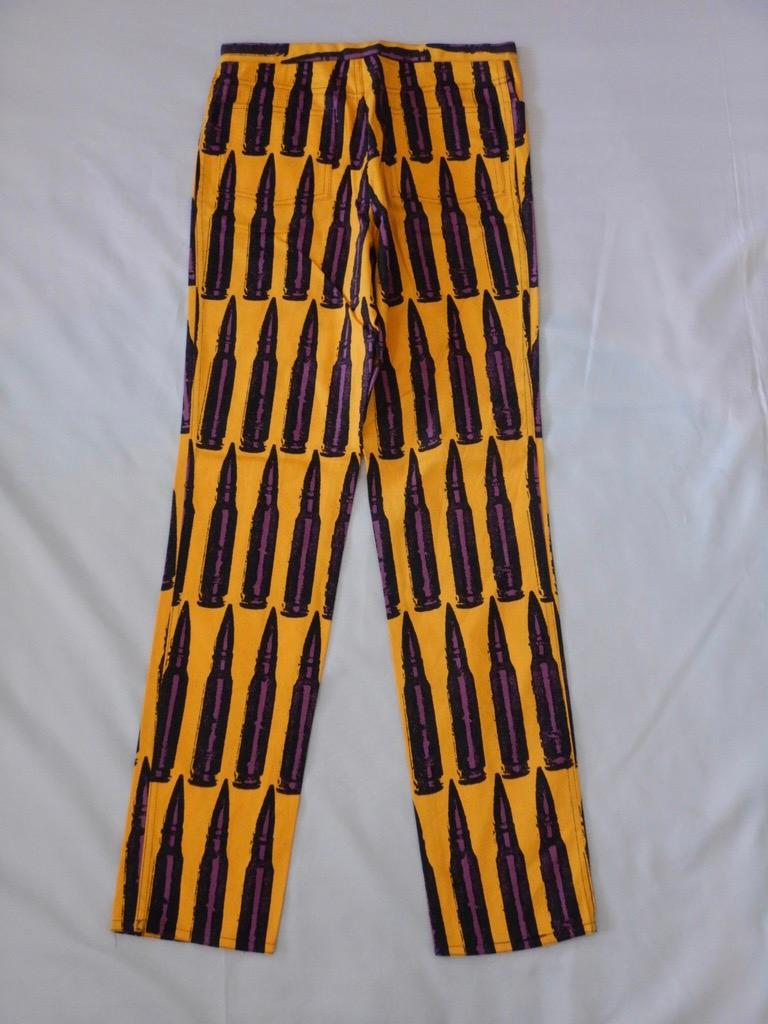 Stephen Sprouse cotton pants from Fall/Winter 1988, purple bullets on a yellow background. 100% cotton, tagged size 32. The pants are in excellent condition with no flaws.

