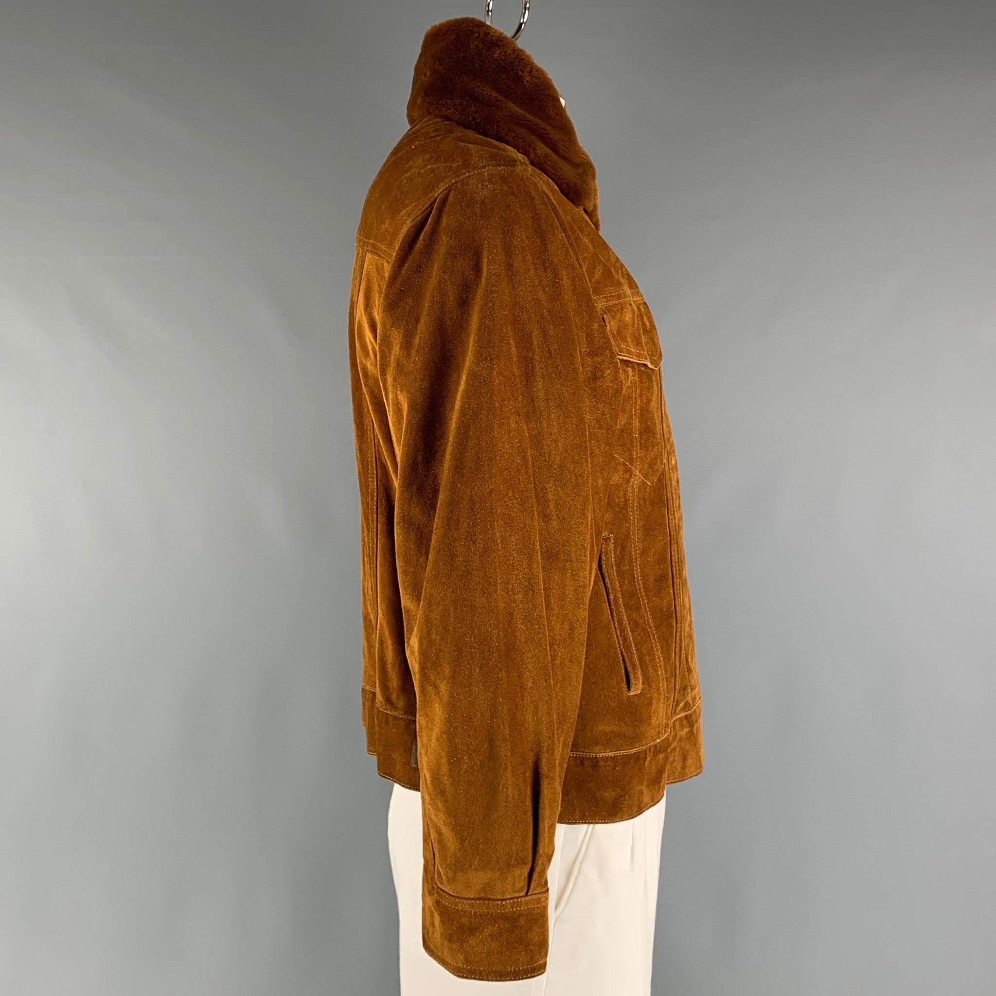 STEPHEN SPROUSE jacket comes in a brown suede featuring a trucker style, removable faux fur collar, front pockets, and a velcro closure. Very Good Pre-Owned Condition. Minor signs of wear. 

Marked:   42 

Measurements: 
 
Shoulder: 20 inches Chest: