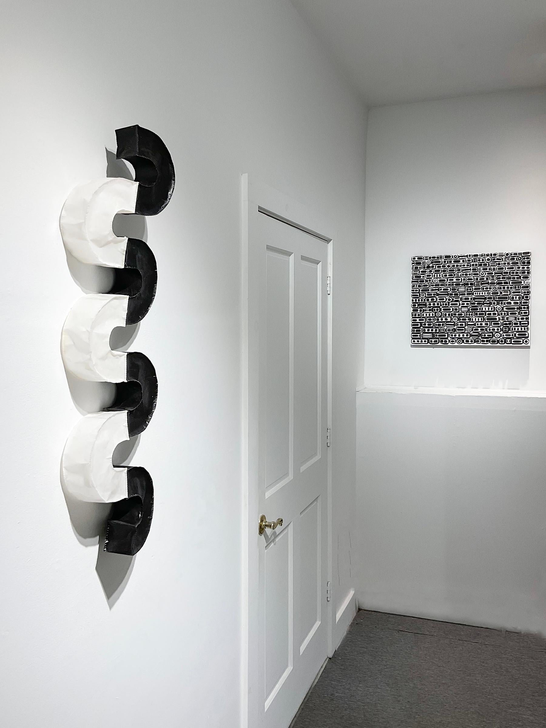 Abstract geometric three-dimensional wood wall sculpture in black and white
