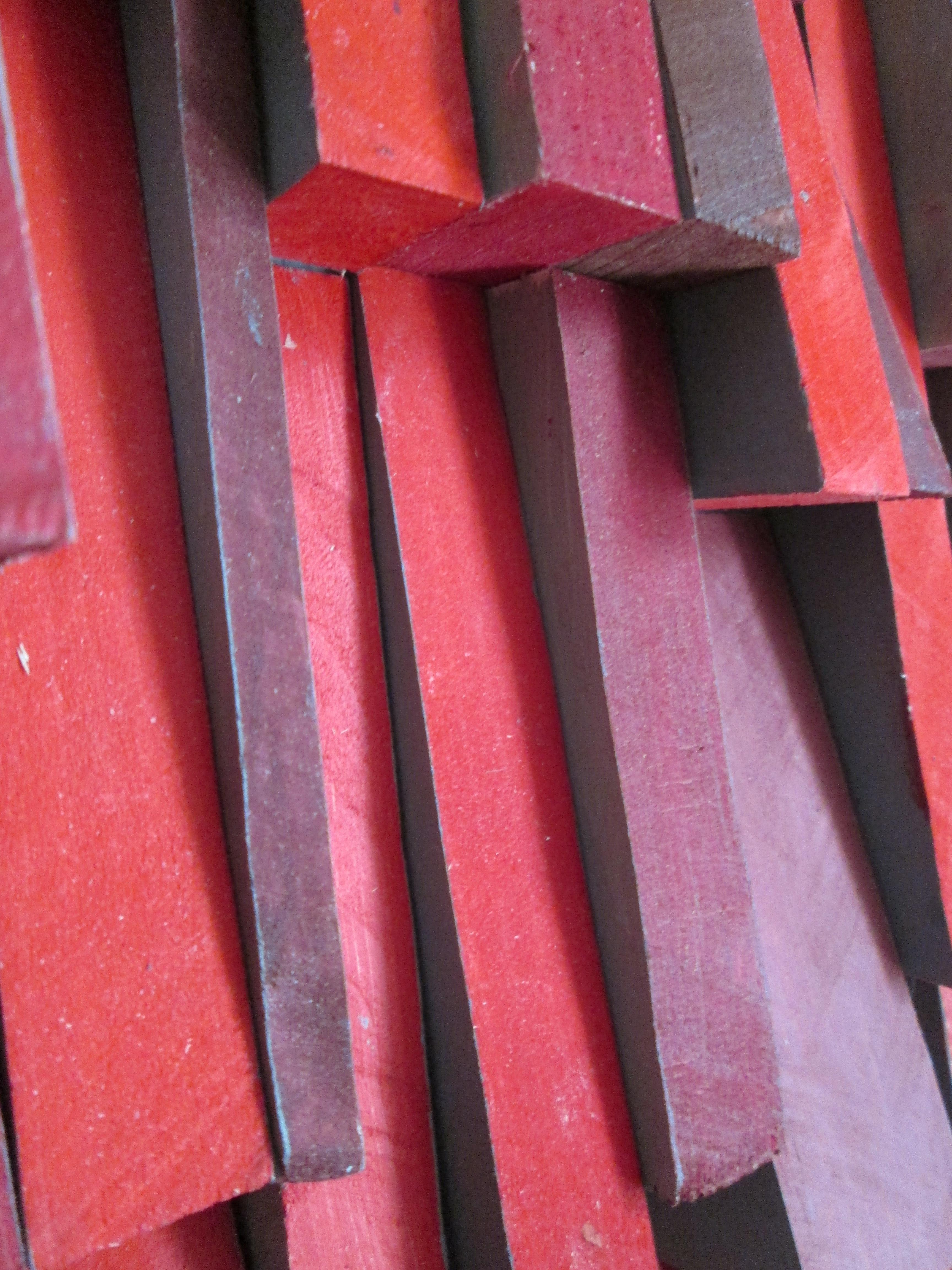 Abstract three dimensional wood wall sculpture in shades of bright red with dark gray painted sides
“Firefall” by Hudson Valley artist, Stephen Walling, made in 2020
Hand carved wood with acrylic paint on panel 
48 x 24 x 3 inches 
Wire backing for