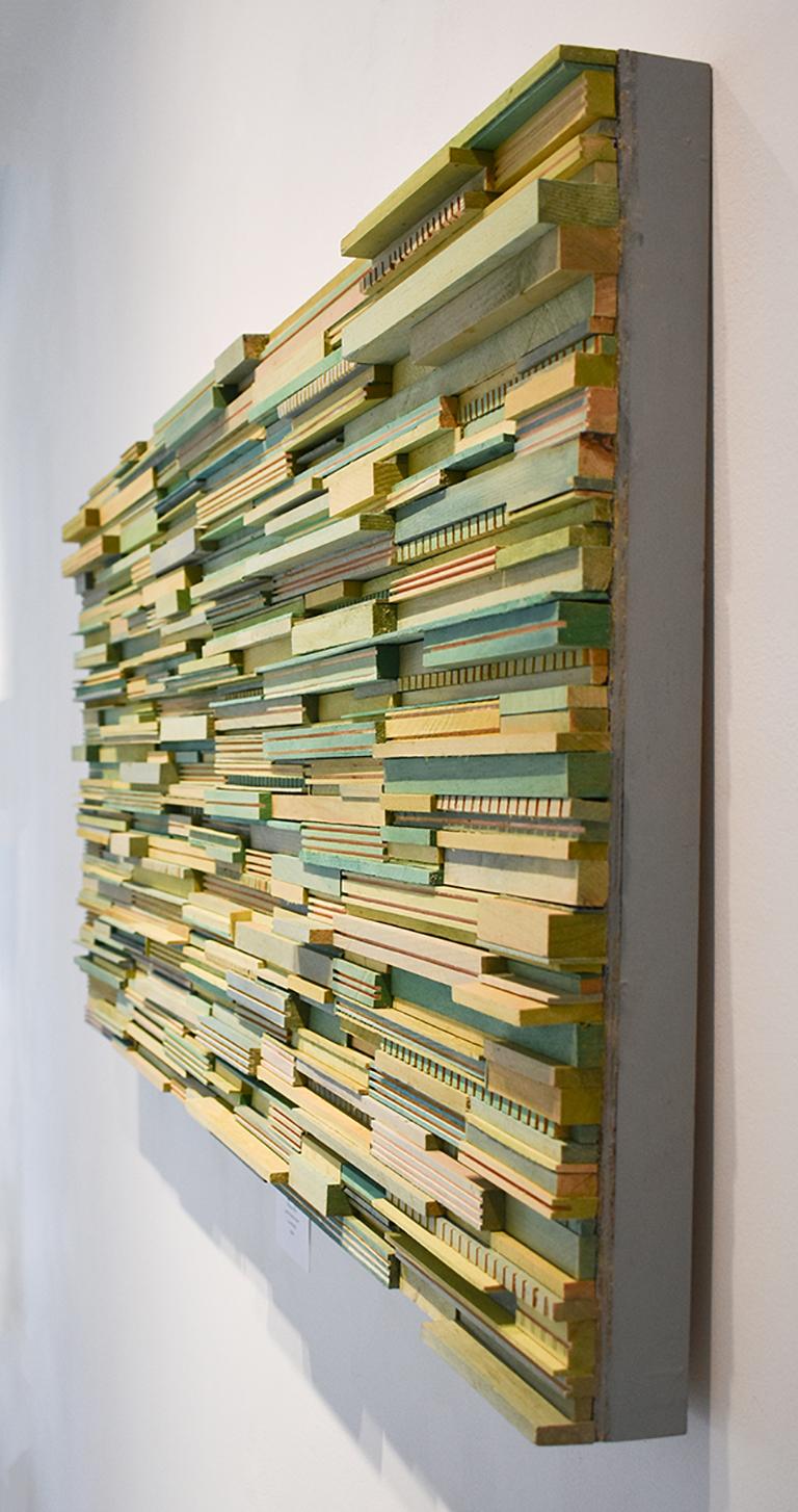 Abstract three-dimensional wall sculpture, acrylic and wood on panel 
Carved strips of wood painted in shades of green, sides are painted dusty blue so framing is not necessary
24 x 48 x 2 inches, can be oriented vertically or horizontally 
Art is