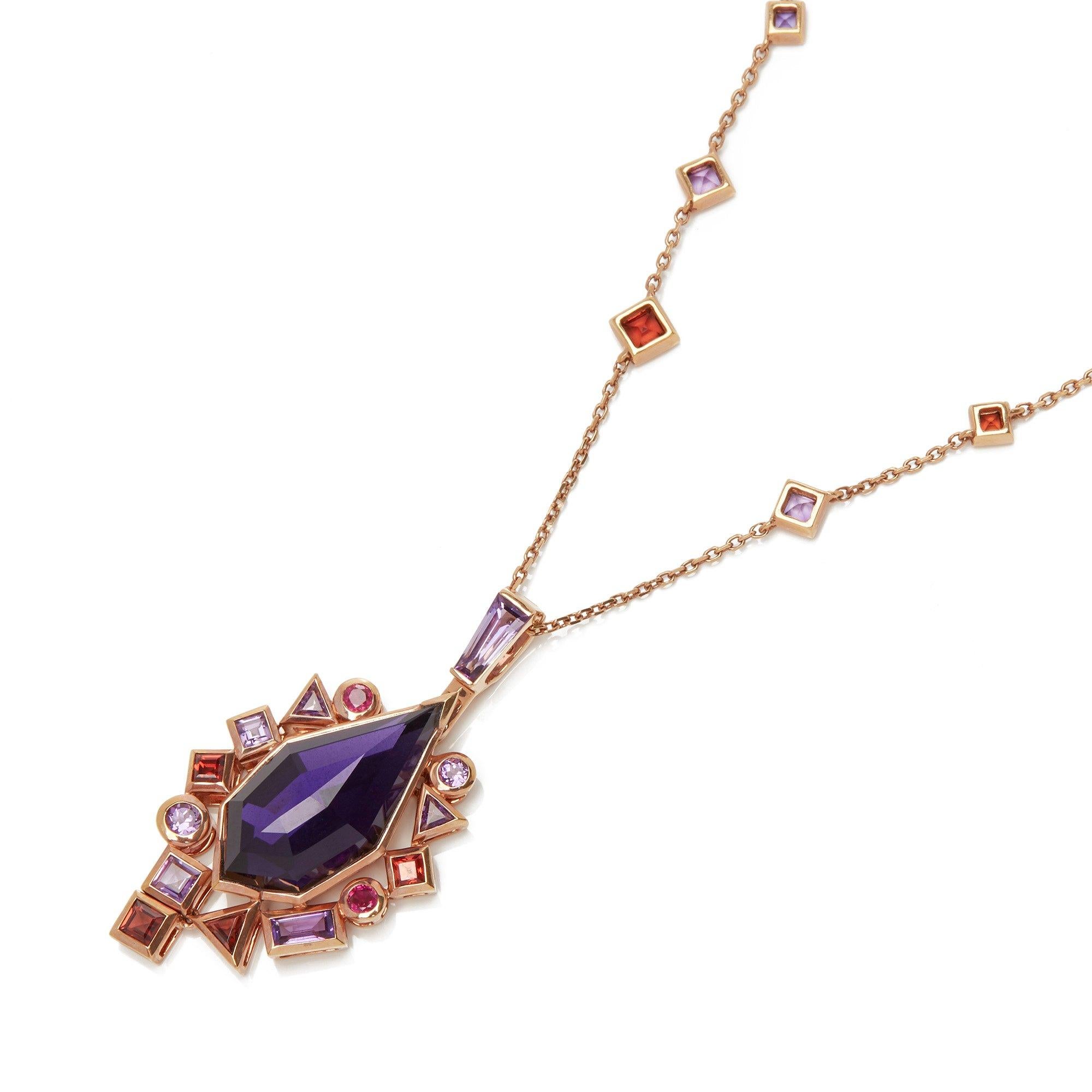 This Pendant by Stephen Webster is from his Crystal Haze Gold Struck Collection and features One Synthetic Amethyst Totalling 1.41cts Surrounded by mixed cut Amethyst and Red Garnets. Set in 18k Rose Gold with 45cm Rose Gold Trace Link Chain. 