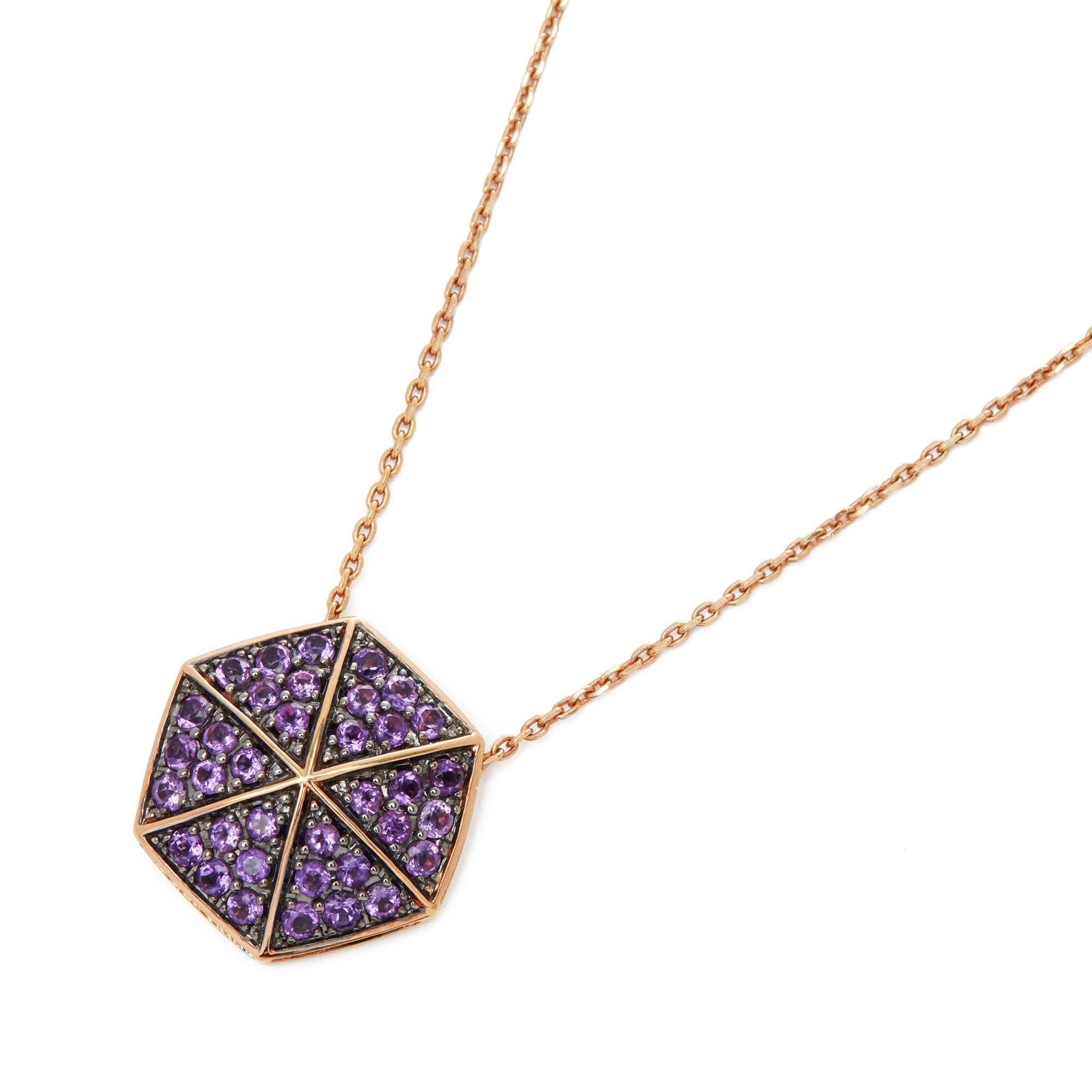 This Pendant by Stephen Webster is from his Deco Collection and features Six Pave Round Amethyst set sections with a total of Thirty Six stones forming a Hexagonal shape. Set in 18k Rose Gold with 41cm Trace Link Chain. 