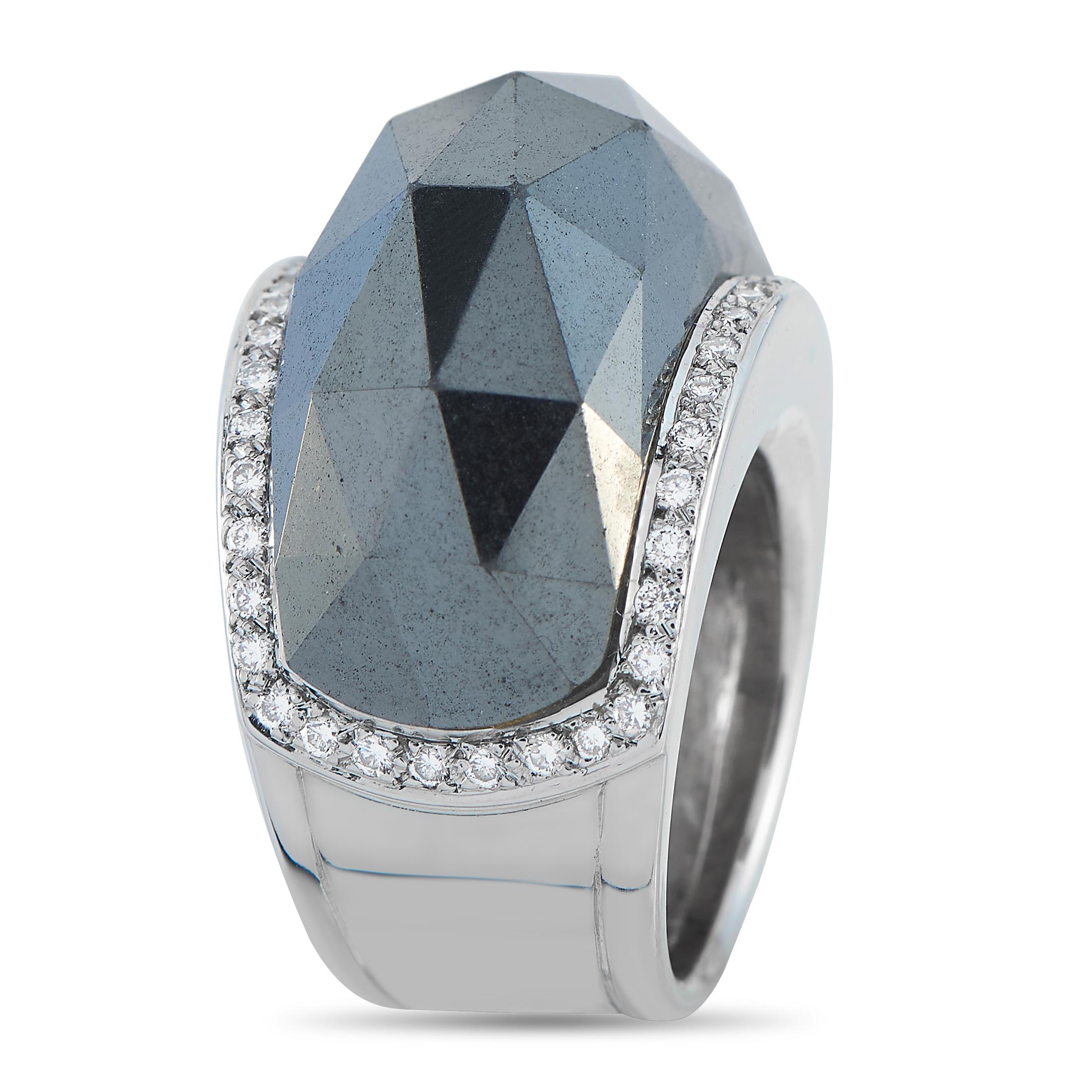 A geometric design makes this Stephen Webster ring impossible to ignore. Inset Diamond accents totaling 0.55 carats elevate the 18K White Gold setting, while a striking Hematite stone at the center adds texture and dimension. It features a 10mm wide