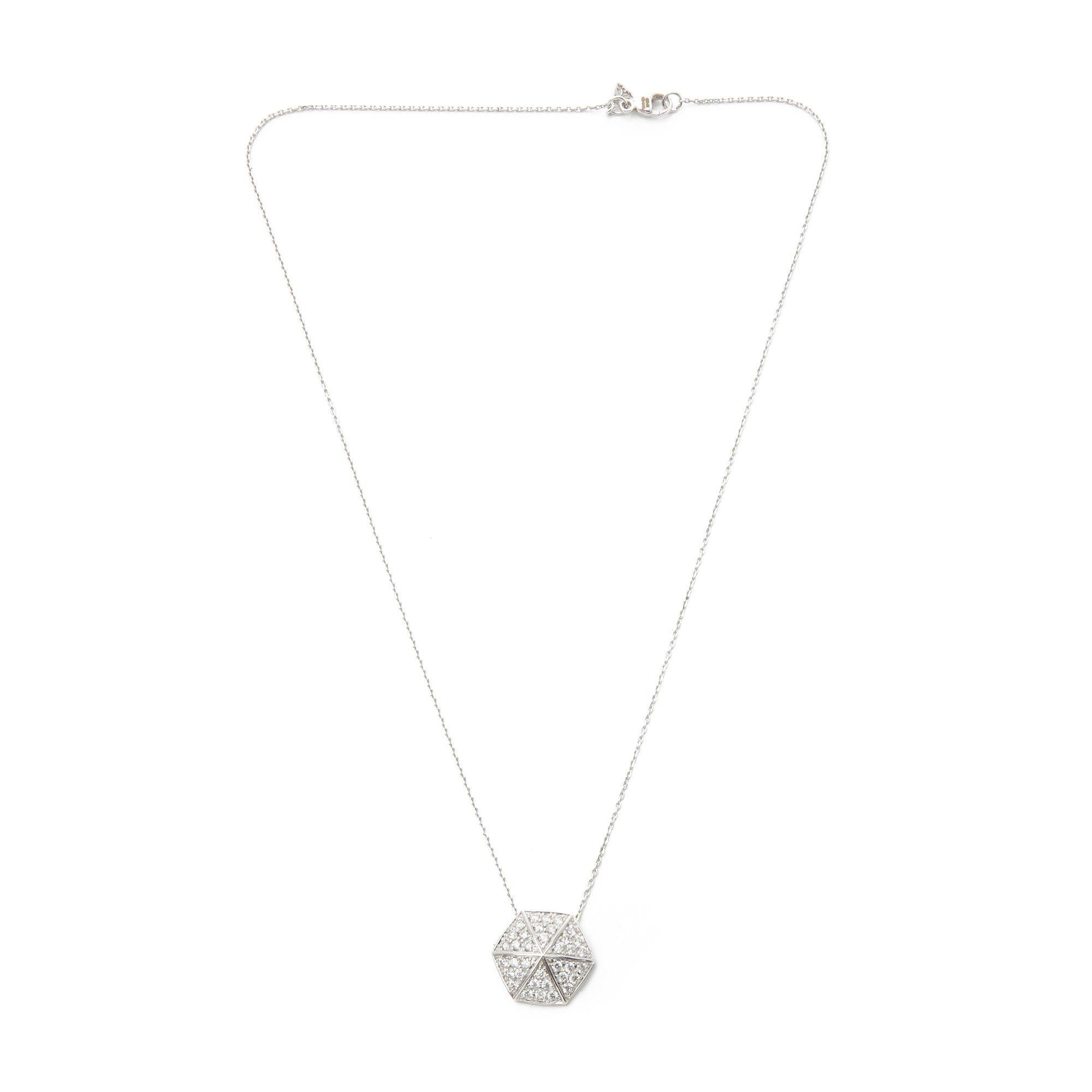 This Pendant by Stephen Webster is from his Deco Collection and features Six Pave Round Briliant Diamond set sections with a total of Thirty Six stones forming a Hexagonal shape. Set in 18k White Gold with 41cm Trace Link Chain. Complete with Xupes