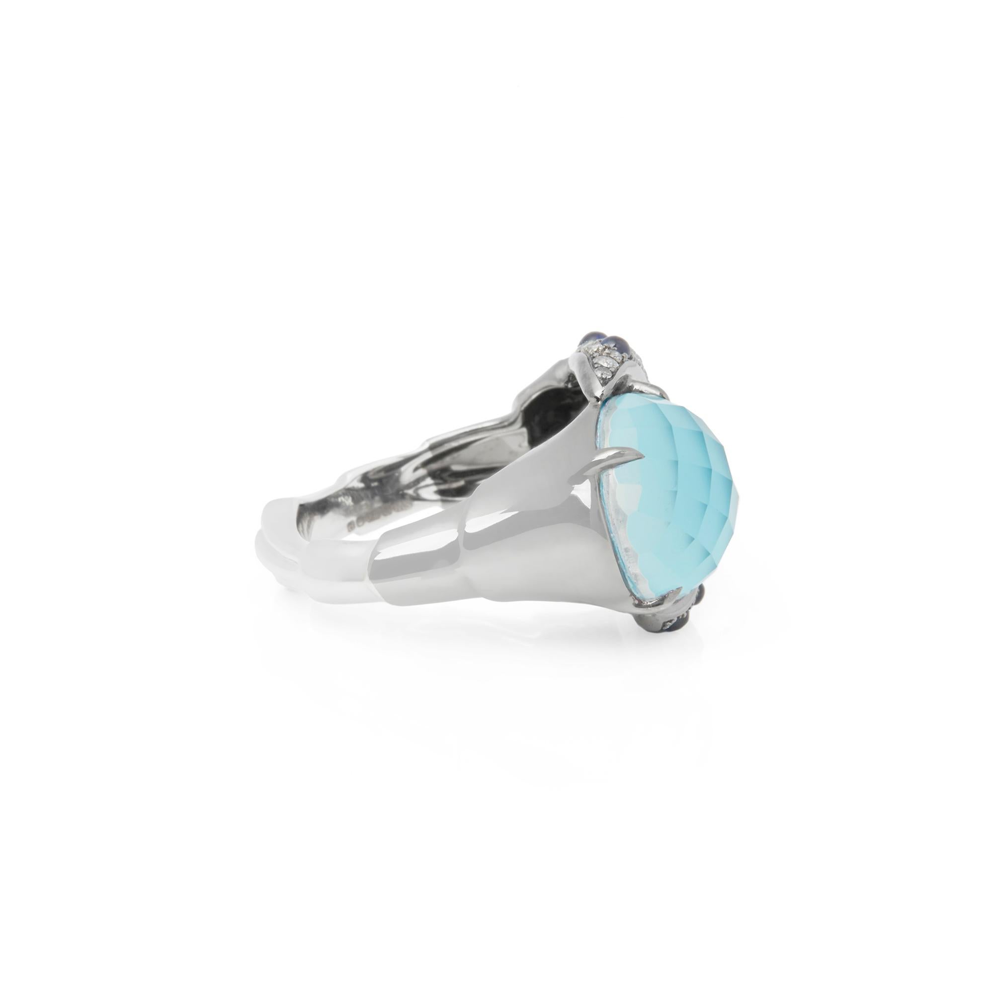 This Ring by Stephen Wenster is from his Jewels Verne Collection and features a faceted Turquoise Claw set surrounded by Pave set with Diamonds and Cabochon Sapphires Totalling 1.09cts. Set in 18k White Gold. UK ring size N1/2. 