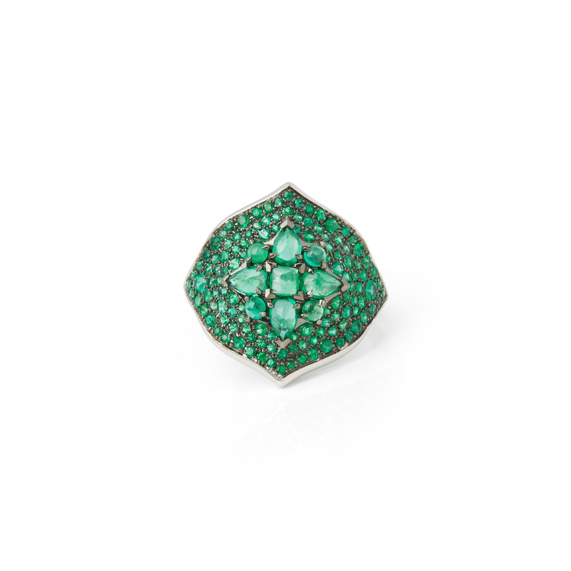 This ring by Stephen Webster is from his Belle Epoque collection and features a combination of round cut pave set and cabochon emerald stones. Set in white gold with a signature band. 
