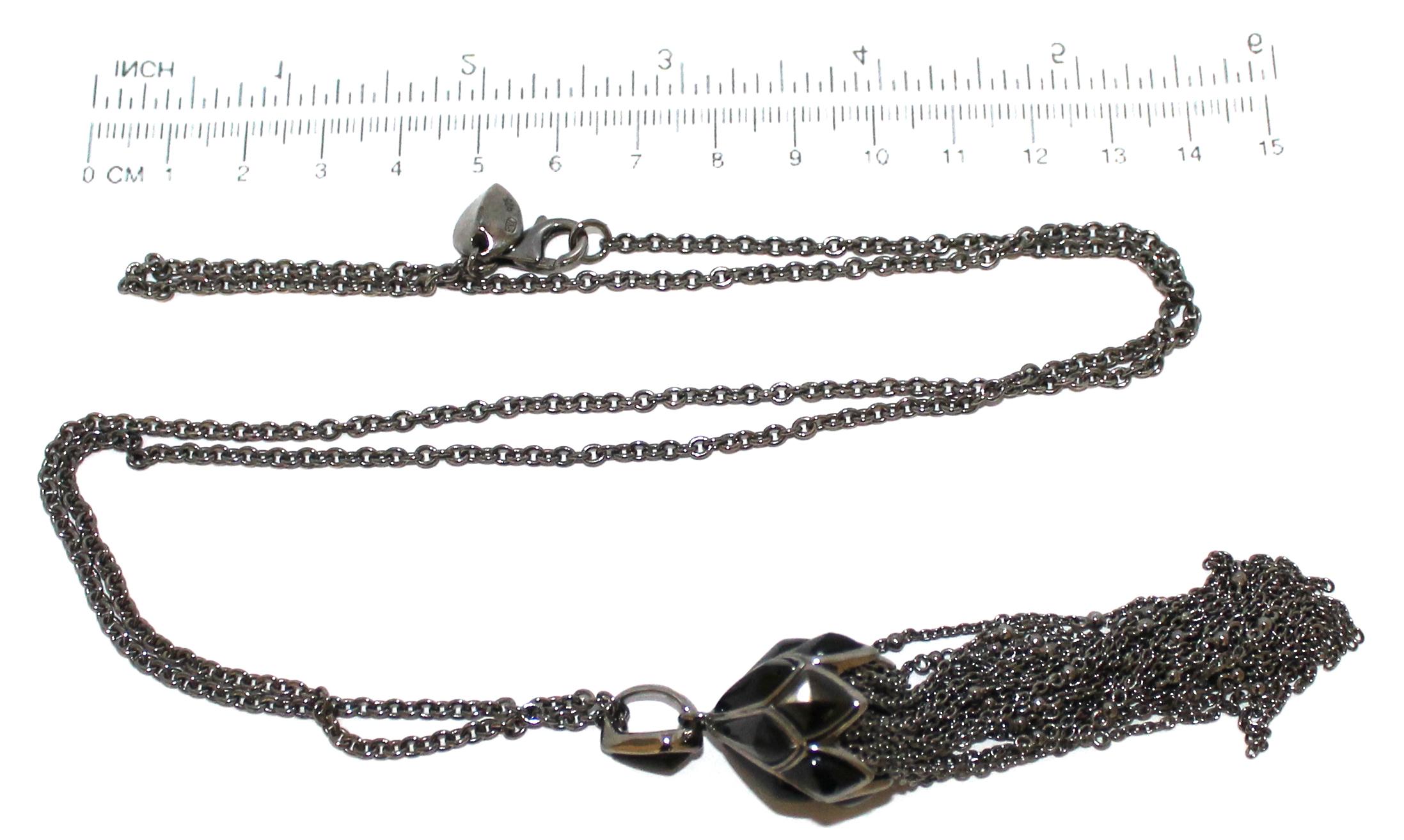 A decorative blackened silver tassel pendant with chain by Stephen Webster, London hallmarked.